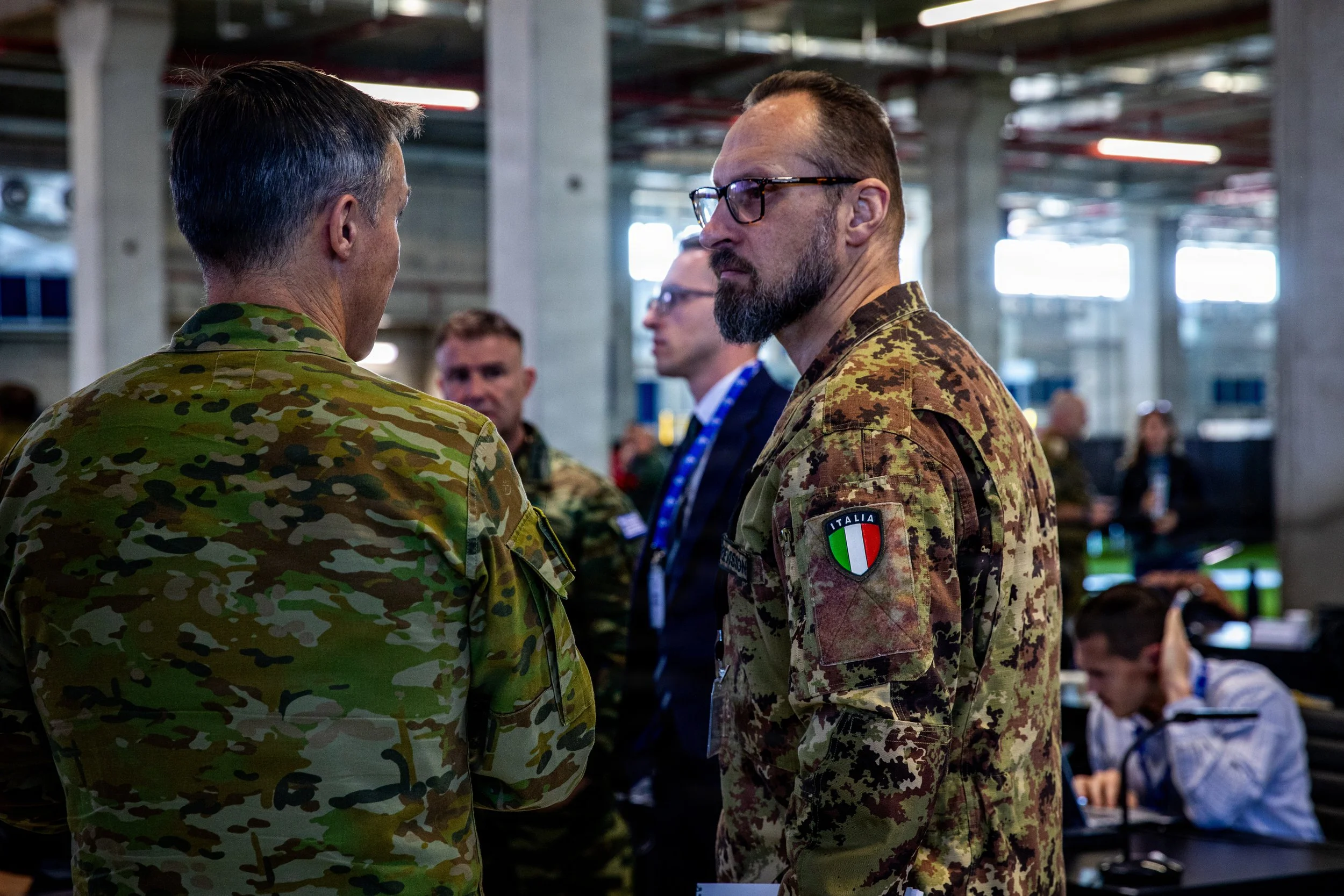 KIRYAT GAT, Israel -- Italian Army Lt. Col. Andrea Trevisson discusses operations with partners and non-governmental organizations inside the Civil-Military Coordination Center (CMCC), Dec. 18, 2025. (U.S. Army photo by Sgt. Kathryn Skonning)
