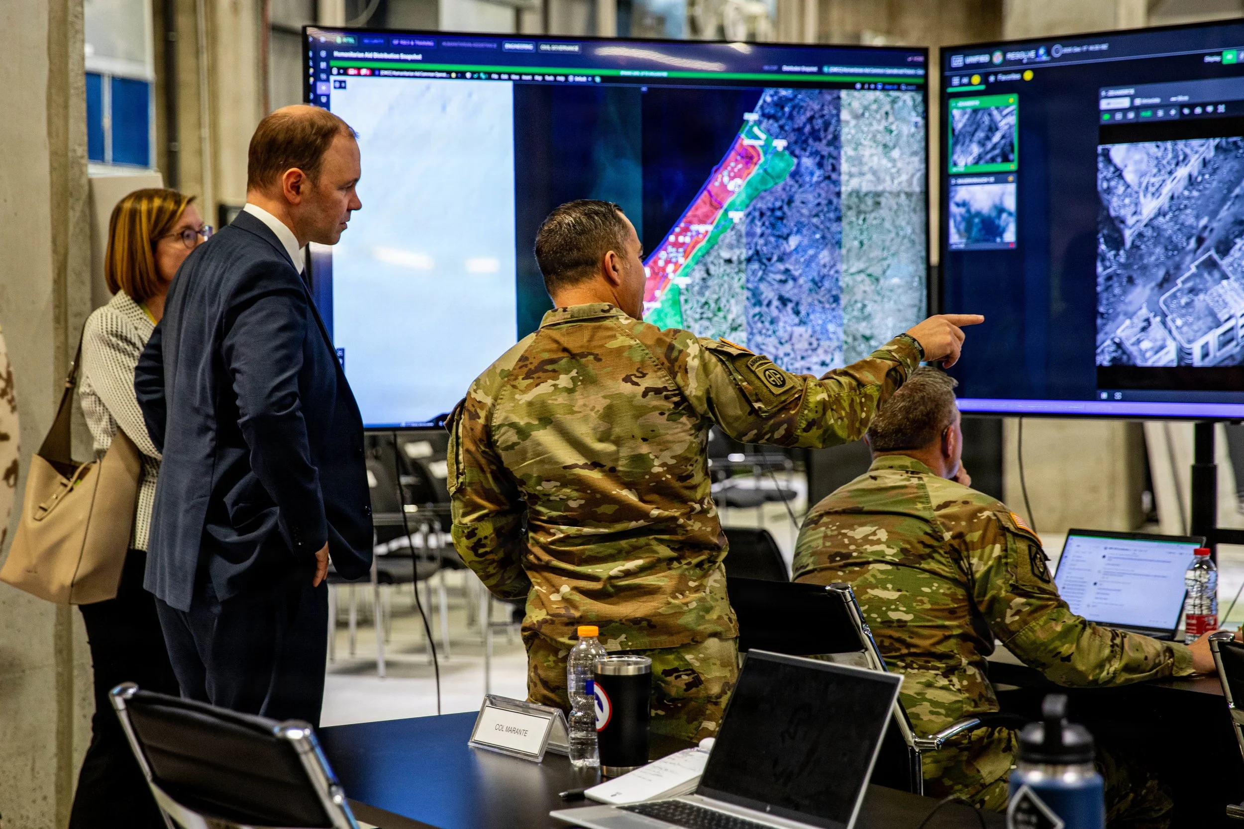KIRYAT GAT, Israel -- U.S. Army Col. Anthony Marante talks with Nils Hilmer, German State Secretary at the Federal Ministry of Defence, about humanitarian assistance route observation and analysis in the Civil-Military Coordination Center (CMCC), Dec