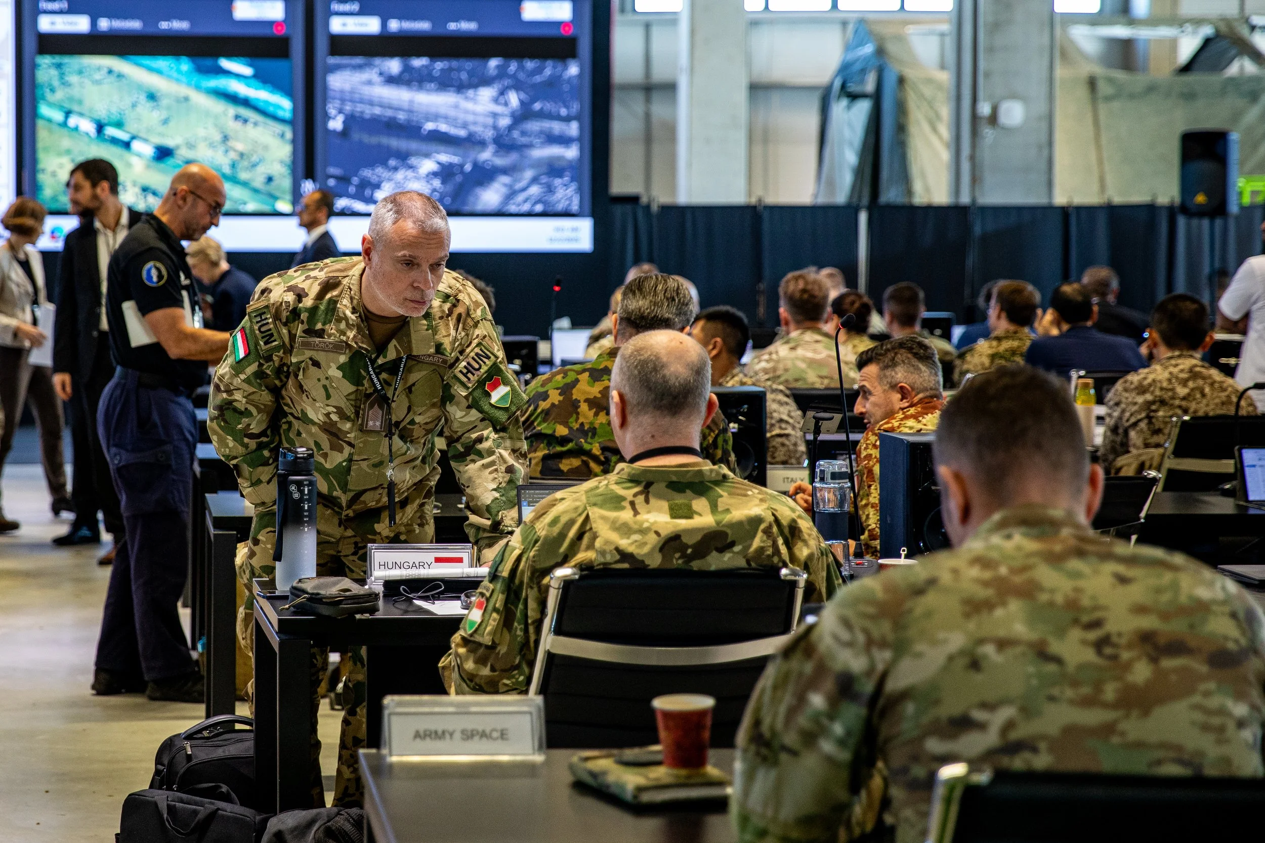 Soldiers assigned to U.S. Army Central, multinational armed forces, and representatives of Non-Government Organizations (NGO) discuss humanitarian aid operations inside the Civil-Military Coordination Center (CMCC) on Dec. 2, 2025, in Israel. The U.S