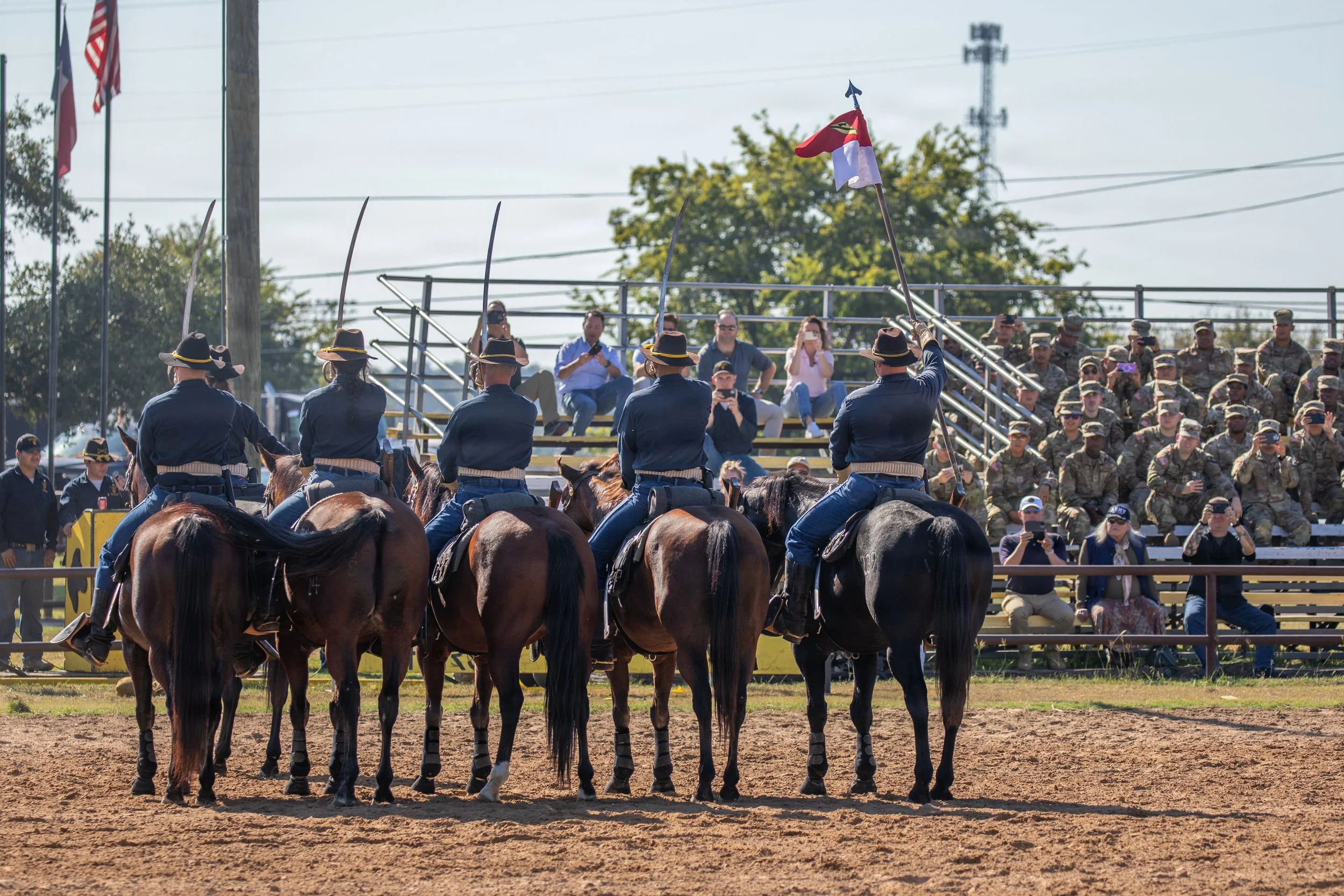 U.S. Army Troopers with the Horse Cavalry Detachment, 1st Cavalry Division, present arms at the conclusion of their mounted cavalry demonstration at the detachment riding arena, Fort Hood, Texas, Oct. 2, 2025. The detachment offers weekly demonstrati