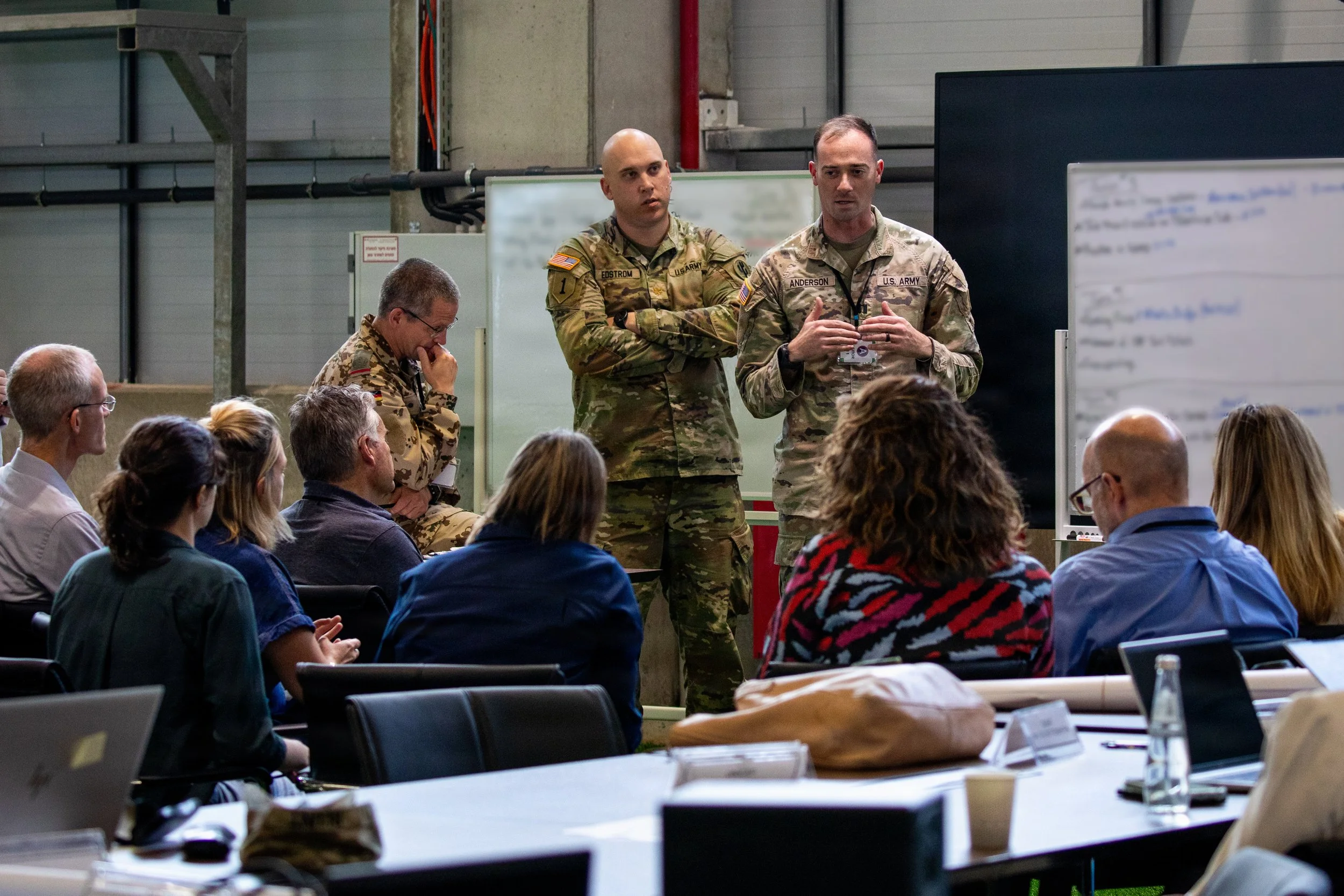 U.S. Army Capt. Joshua Anderson briefs a member of the German Armed Forces, and non-governmental organization (NGO) representatives inside the Civil-Military Coordination Center (CMCC) on Nov. 4, 2025, in Israel. (U.S. Army photo by Spc. Kathryn Skon