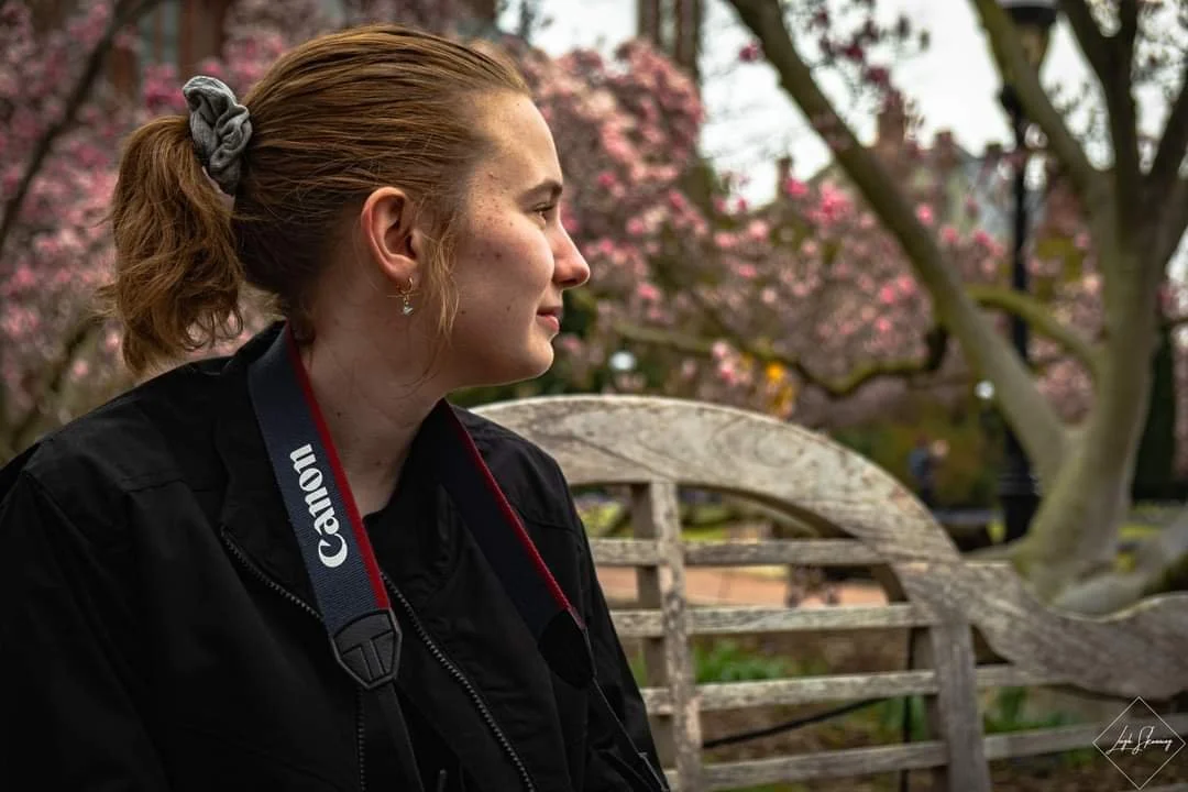 Image of Kathryn sitting on a park bench during a trip to Washington DC. Photo taken by Leigh Skonning.