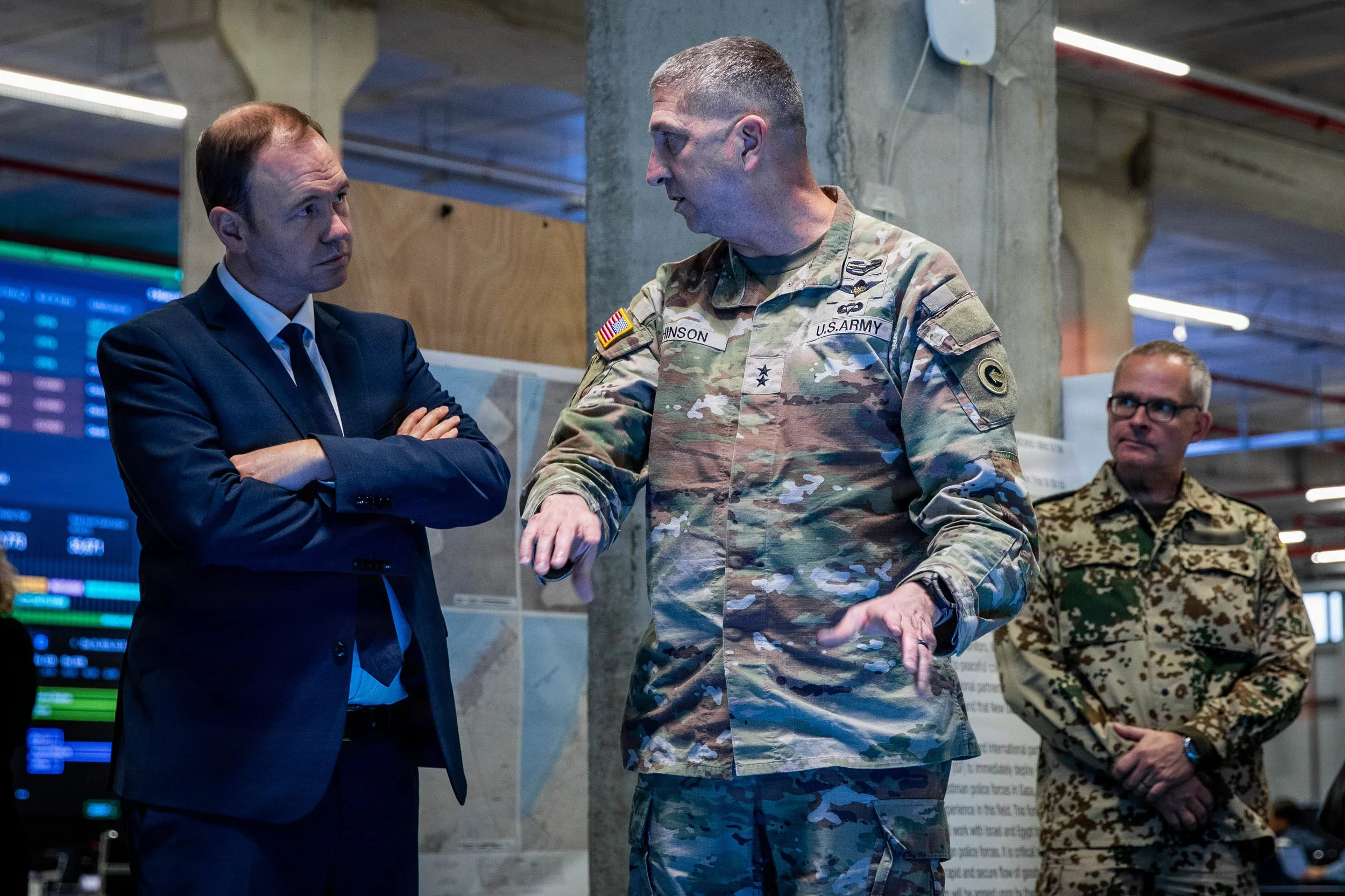 KIRYAT GAT, Israel -- U.S. Army Maj. Gen. Brad Hinson speaks with Nils Hilmer, German State Secretary at the Federal Ministry of Defence, about the humanitarian assistance efforts coordinated by the Civil-Military Coordination Center (CMCC), Dec. 17,