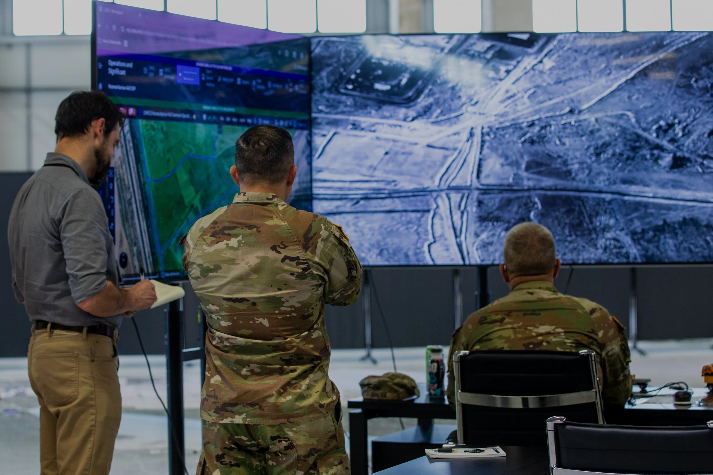 Soldiers assigned to U.S. Army Central and a representative of a Non-Government Organization (NGO) examine humanitarian aid routes in the Civil-Military Coordination Center (CMCC) on Nov. 11, 2025, in Israel. The CMCC is designed to help facilitate t