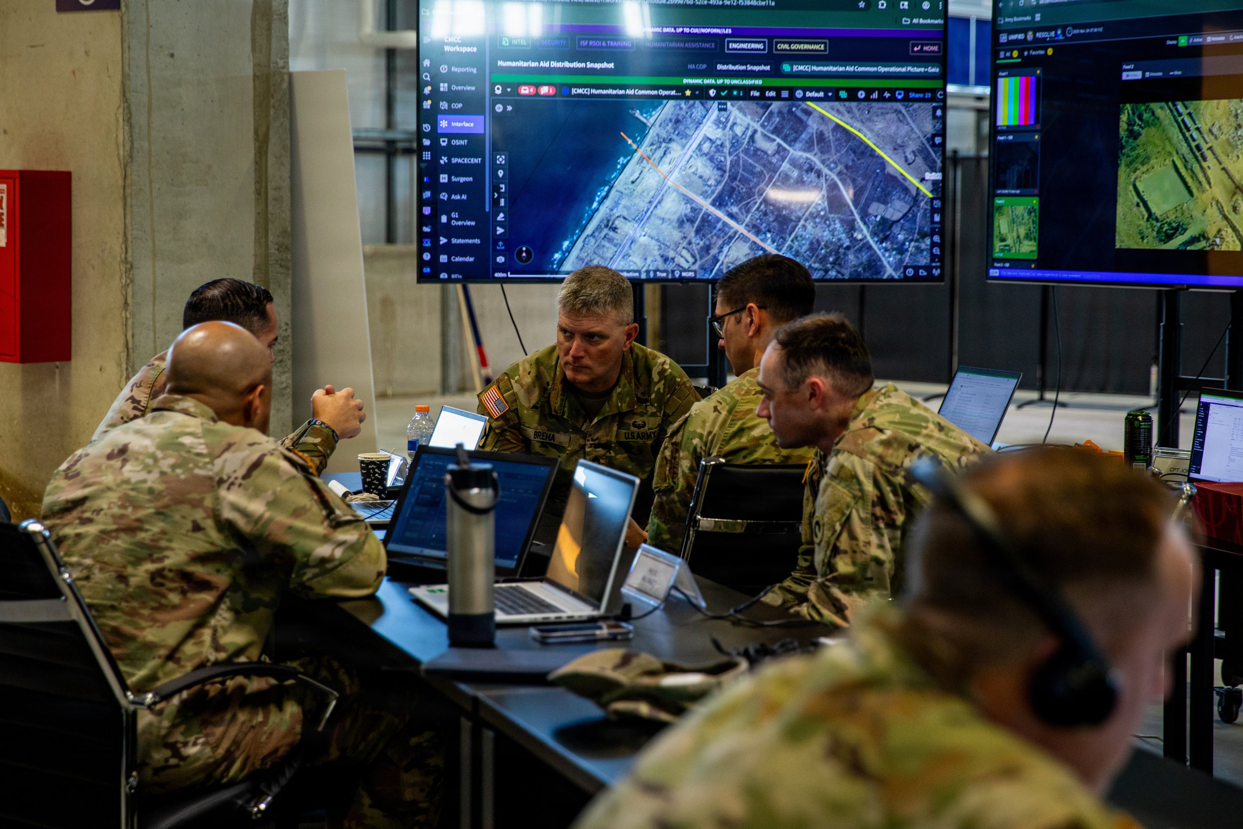 U.S. Army Soldiers assigned to U.S. Army Central, discuss humanitarian aid routes inside the Civil-Military Coordination Center (CMCC) on Nov. 24, 2025, in Israel. The CMCC is designed to help facilitate the flow of humanitarian, logistical, and secu