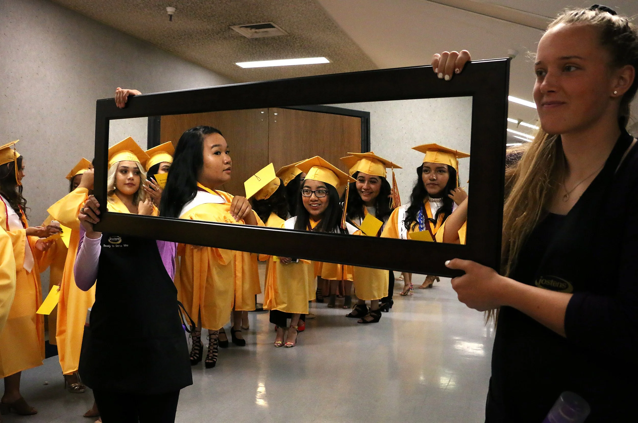 Sparks High School students check themselves in the mirror at their graduation ceremony at Lawlor Events Center in Reno on June 16, 2018. 