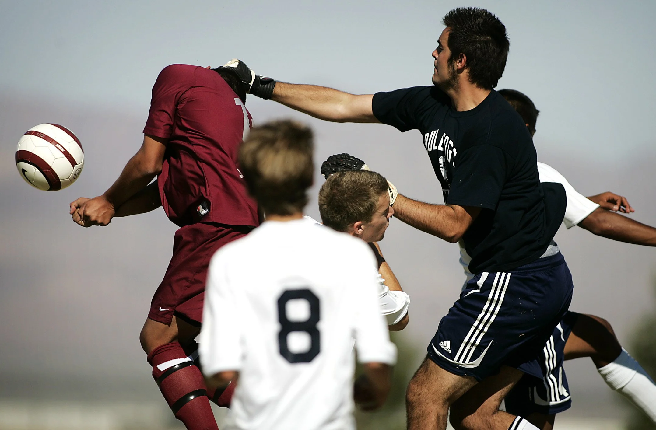 Cimarron High School's Chance Rosa, on left, gets his head knocked sideways by Centennial's goalie Tyler McAninch during a corner kick opportunity during the first half at Centennial High School in Las Vegas on Sept. 24, 2008.