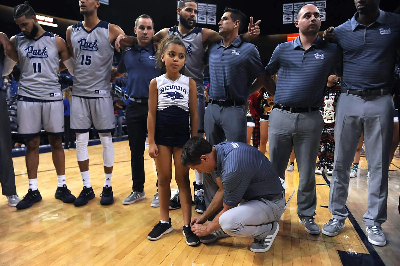Nevada basketball coach Eric Musselman ties his daughter Mariah’s shoe after defeating South Dakota State at Lawlor Events Center in Reno on Dec. 15, 2018.