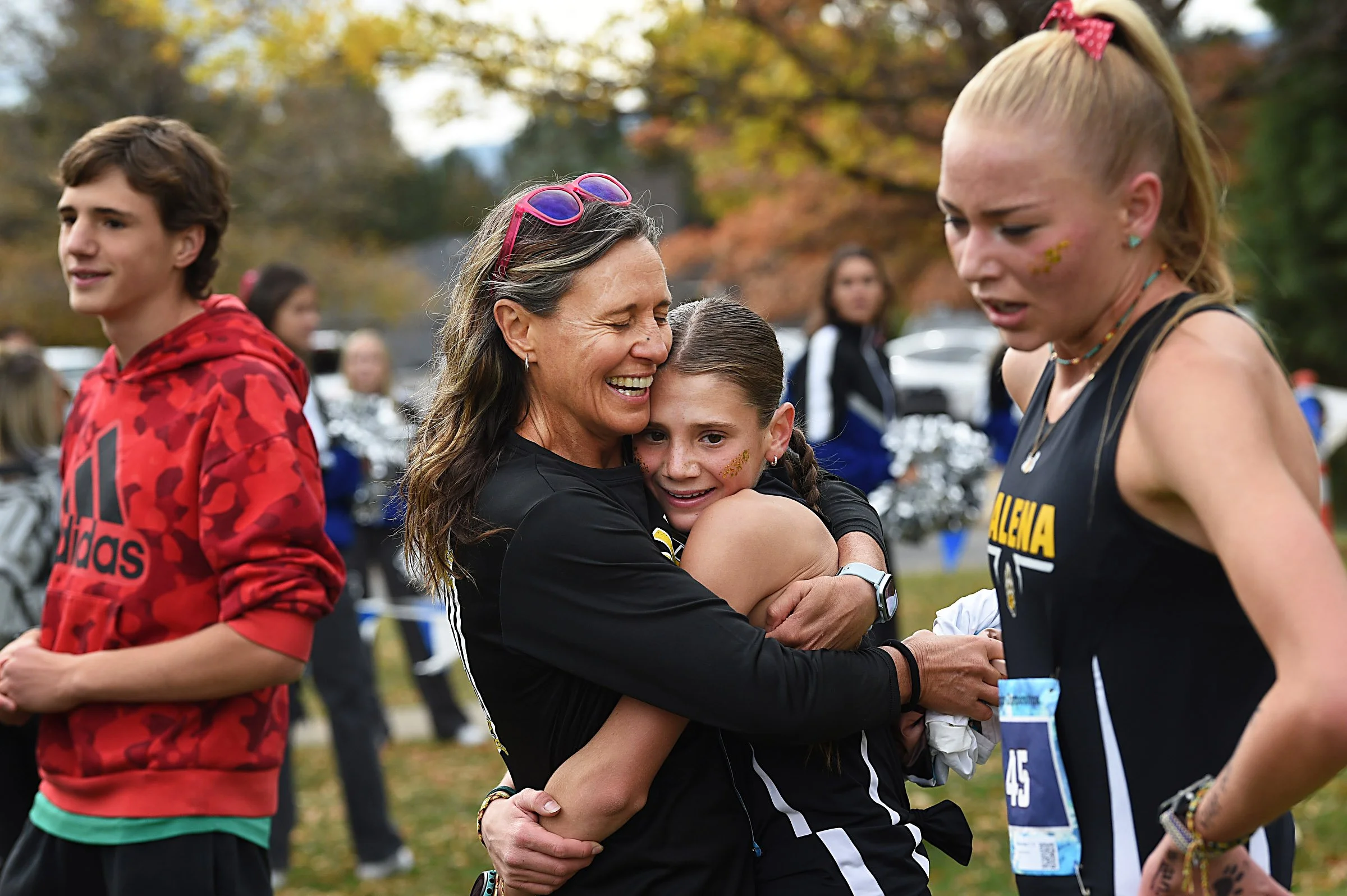 Galena’s Gioia Coudriet, middle, hugs her mom Vanina after winning the NIAA north region girls 5A cross country championship at Rancho San Rafael Regional Park in Reno on Oct. 25, 2024. Second place winner Eleanor Raker, also from Galena, is seen on 