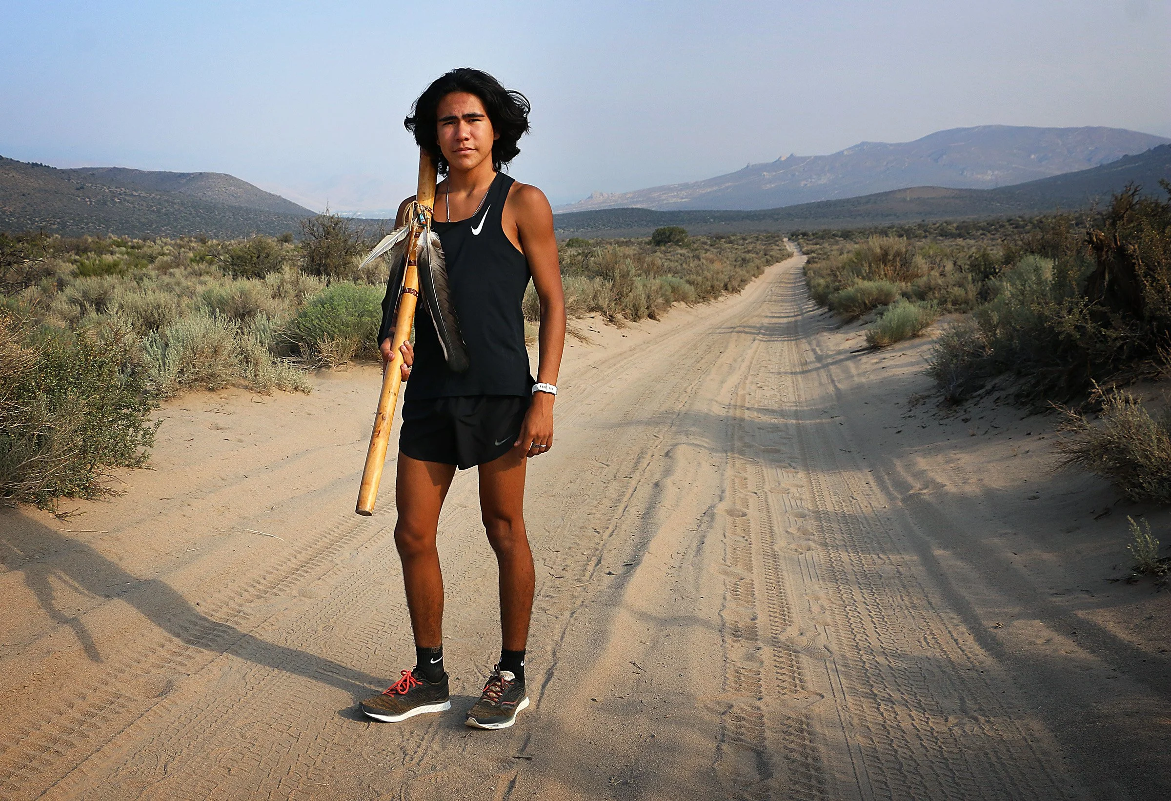 Ku Stevens poses for a portrait while holding the Peace and Dignity Journey's eagle staff about five miles east of Carson City while on the route of the Remembrance Run on Aug. 14, 2021.