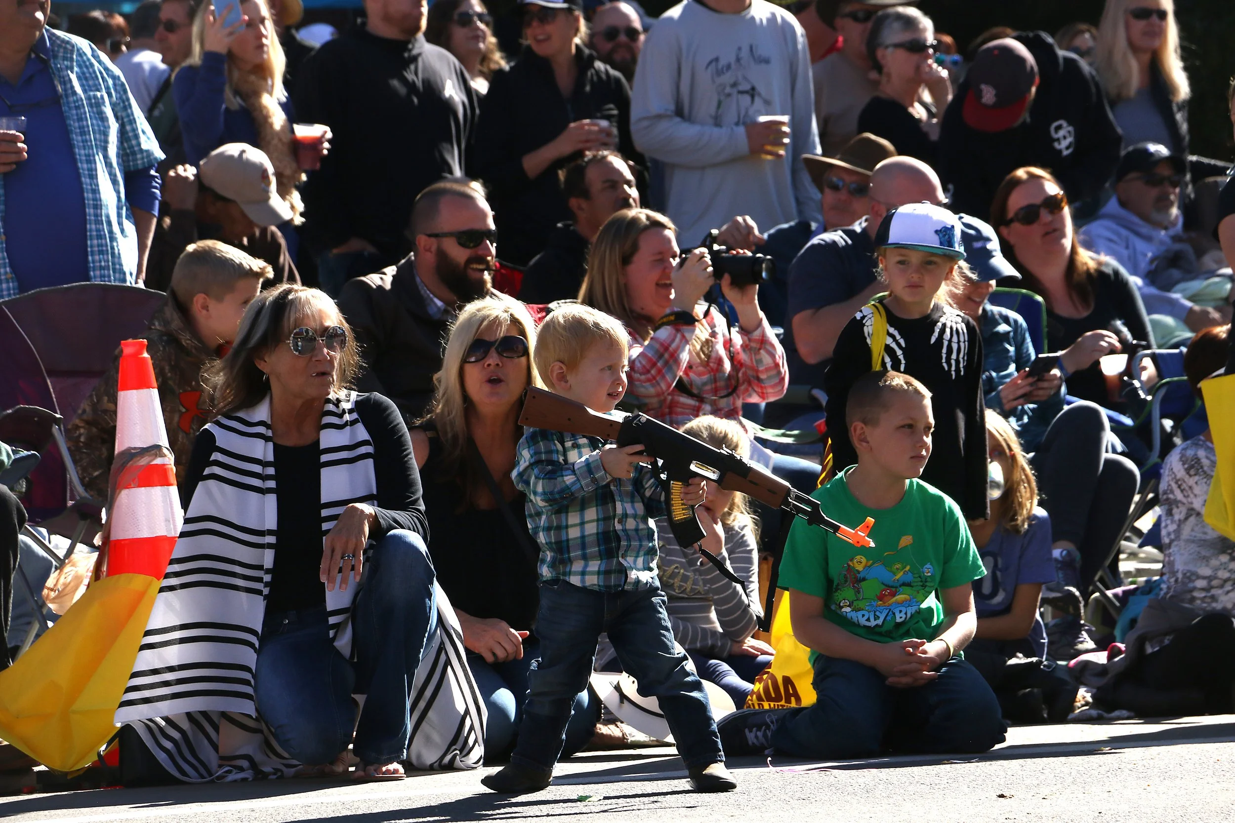 A child plays with a toy gun during the Nevada Day Parade in Carson City on Oct. 28, 2017. 