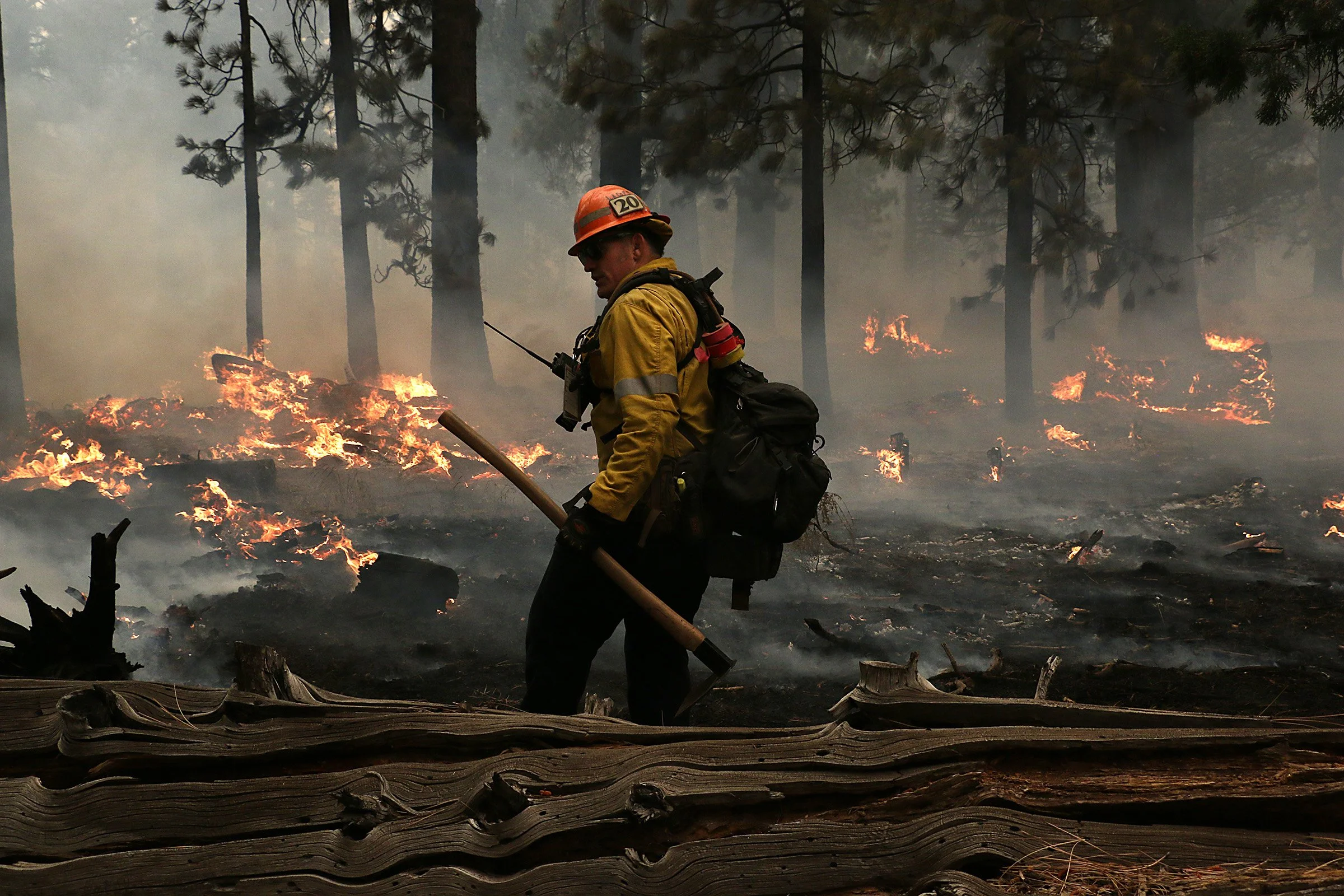 Firefighters with the Los Angeles County Fire Department work to put out the Caldor Fire in the Christmas Valley area of South Lake Tahoe on Aug. 31, 2021.