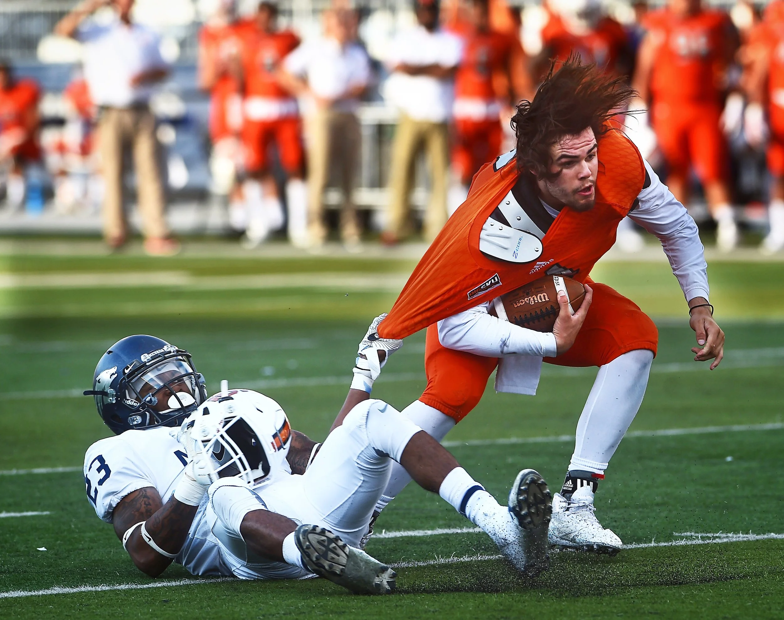 Nevada's D.J. Powe grabs a hold of Idaho State's Tanner Gueller during their football game at Mackay Stadium in Reno on Sept. 16, 2017. 