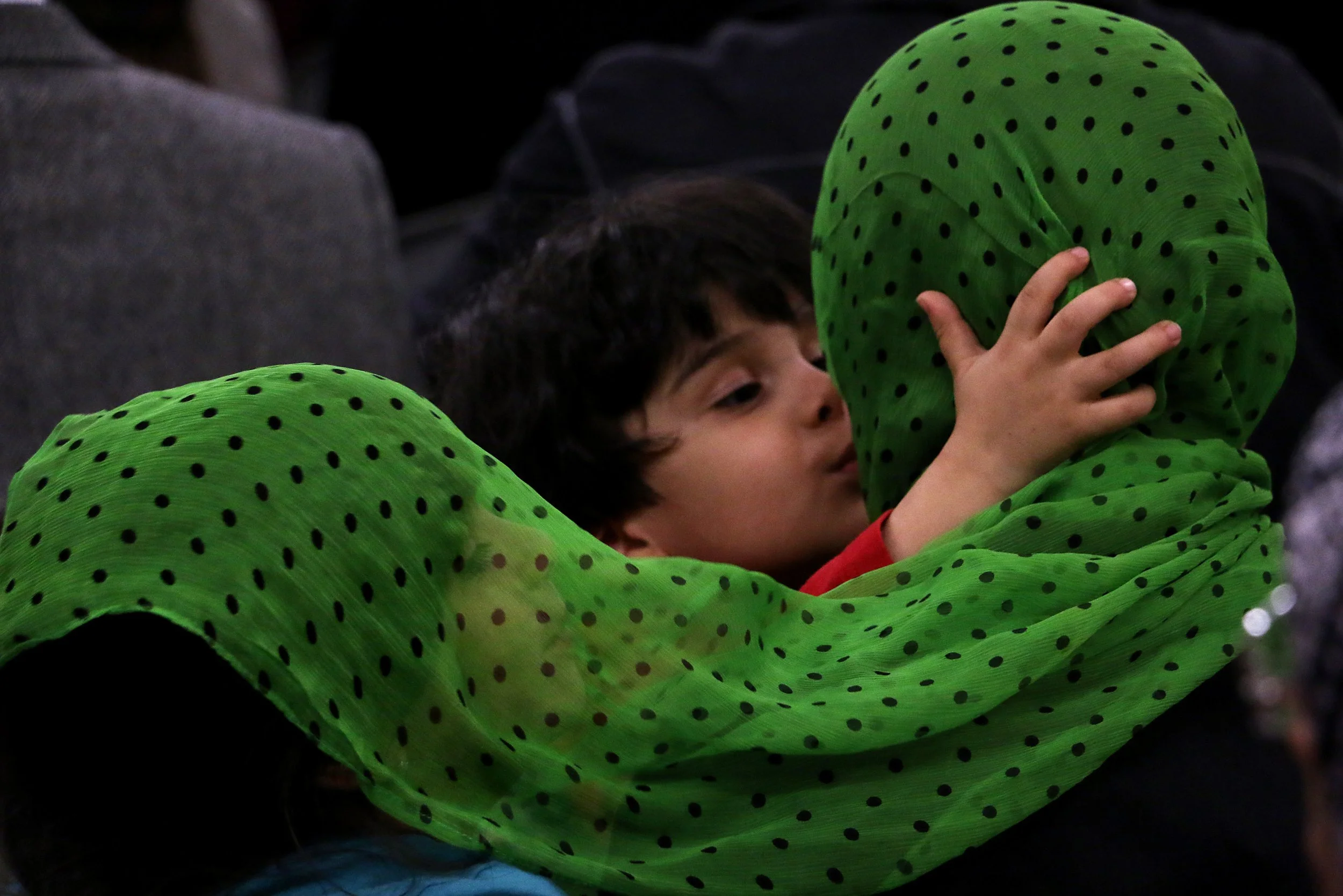 A child kisses his mother during the Northern Nevada Muslim Community's "Hearts United with Christchurch and the Muslim Community" vigil and prayer gathering in Sparks on March 20, 2019.