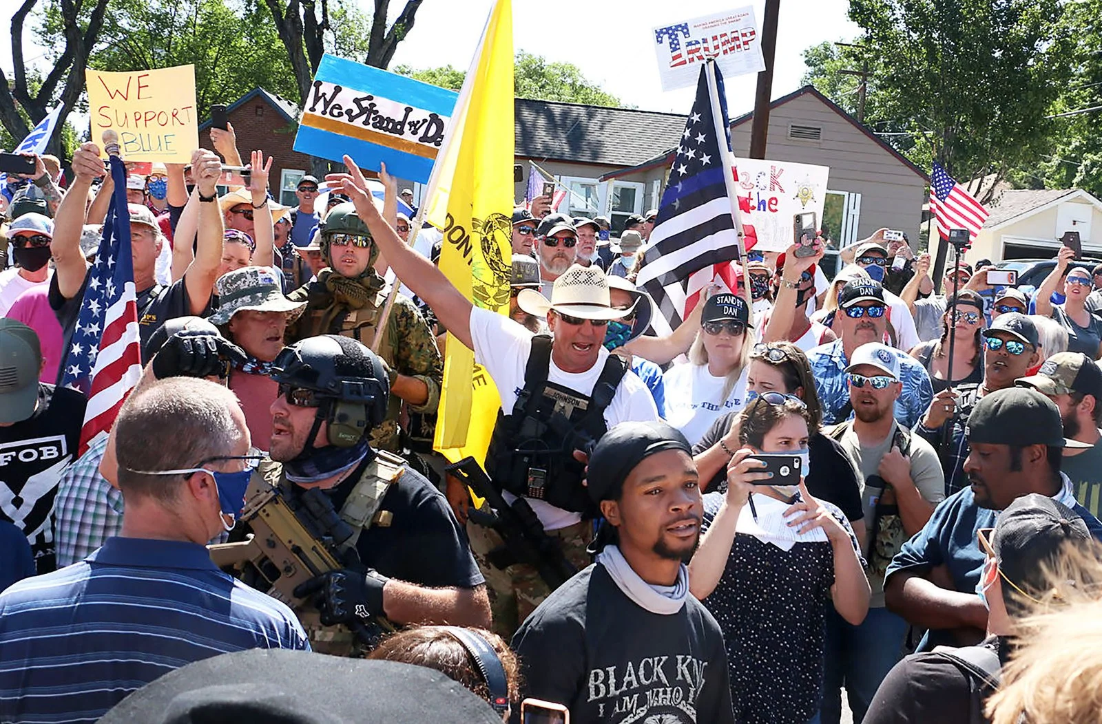 Brian Johnson, middle in white hat, tries his best to protect the first amendment rights of Jerome Silas, front, and his fellow Black Lives Matter protesters as their peaceful demonstration was met by counter protesters in Minden on Aug. 8, 2020.