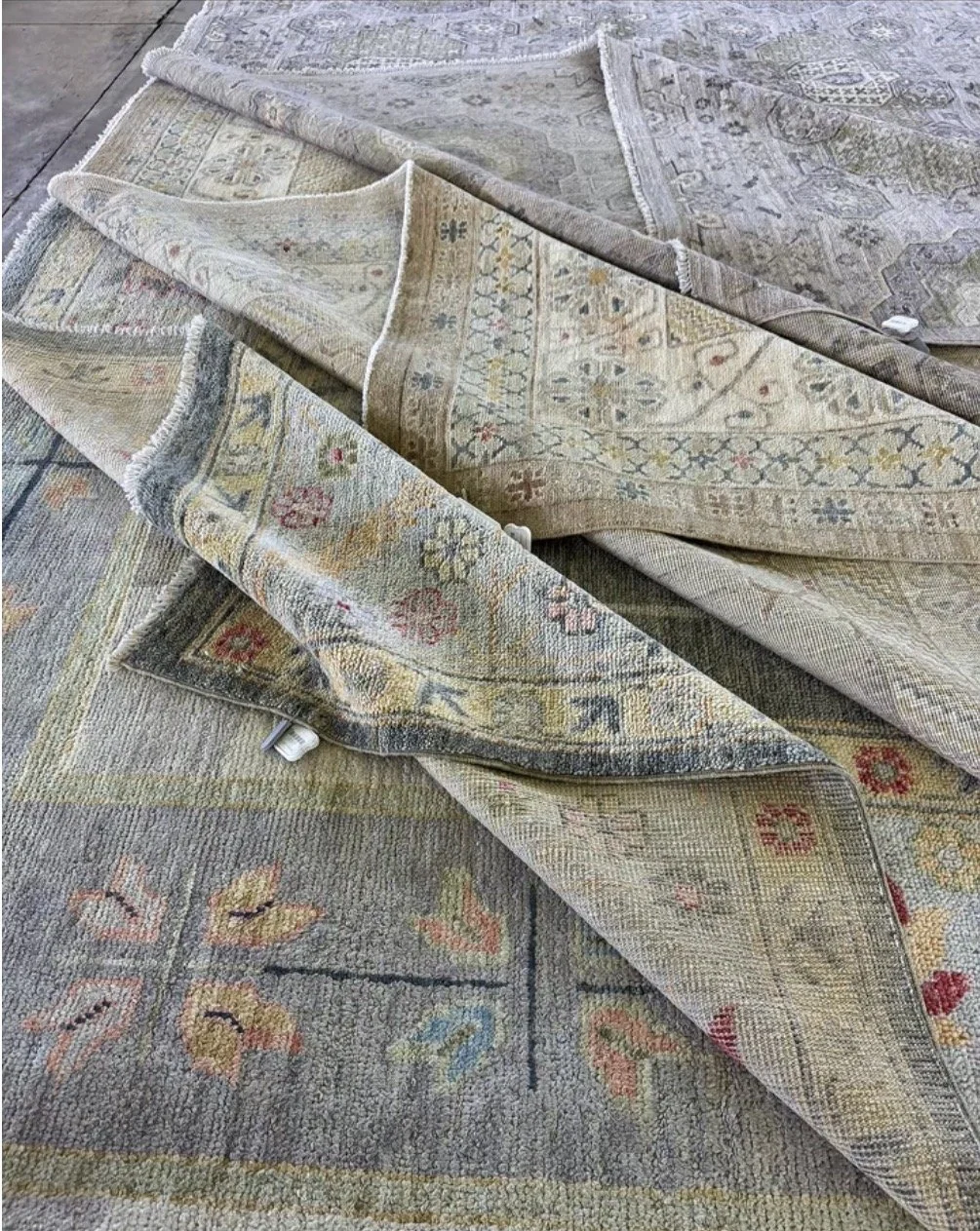 Stack of oushak rugs at the Dallas market center fall 2026.