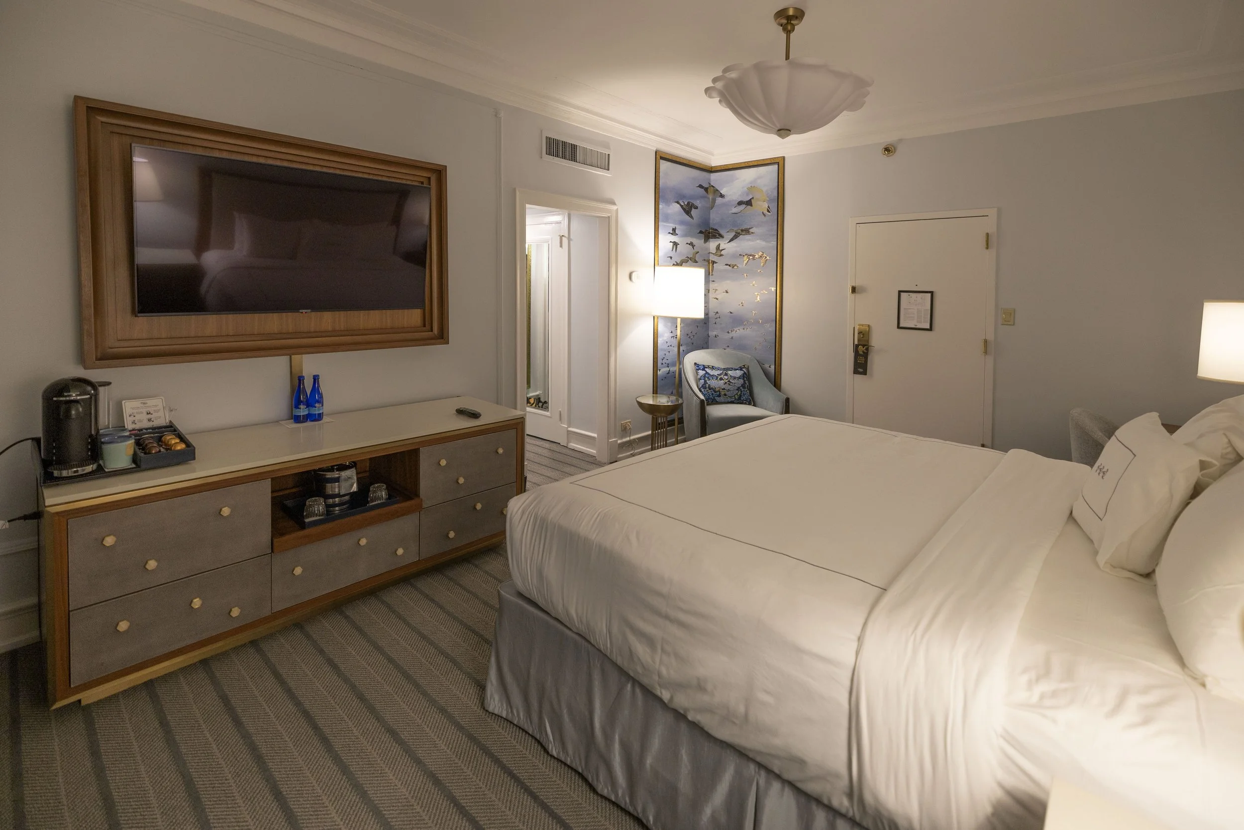 Hotel room with a large bed, a flat-screen TV mounted on the wall. Peabody Hotel Memphis.