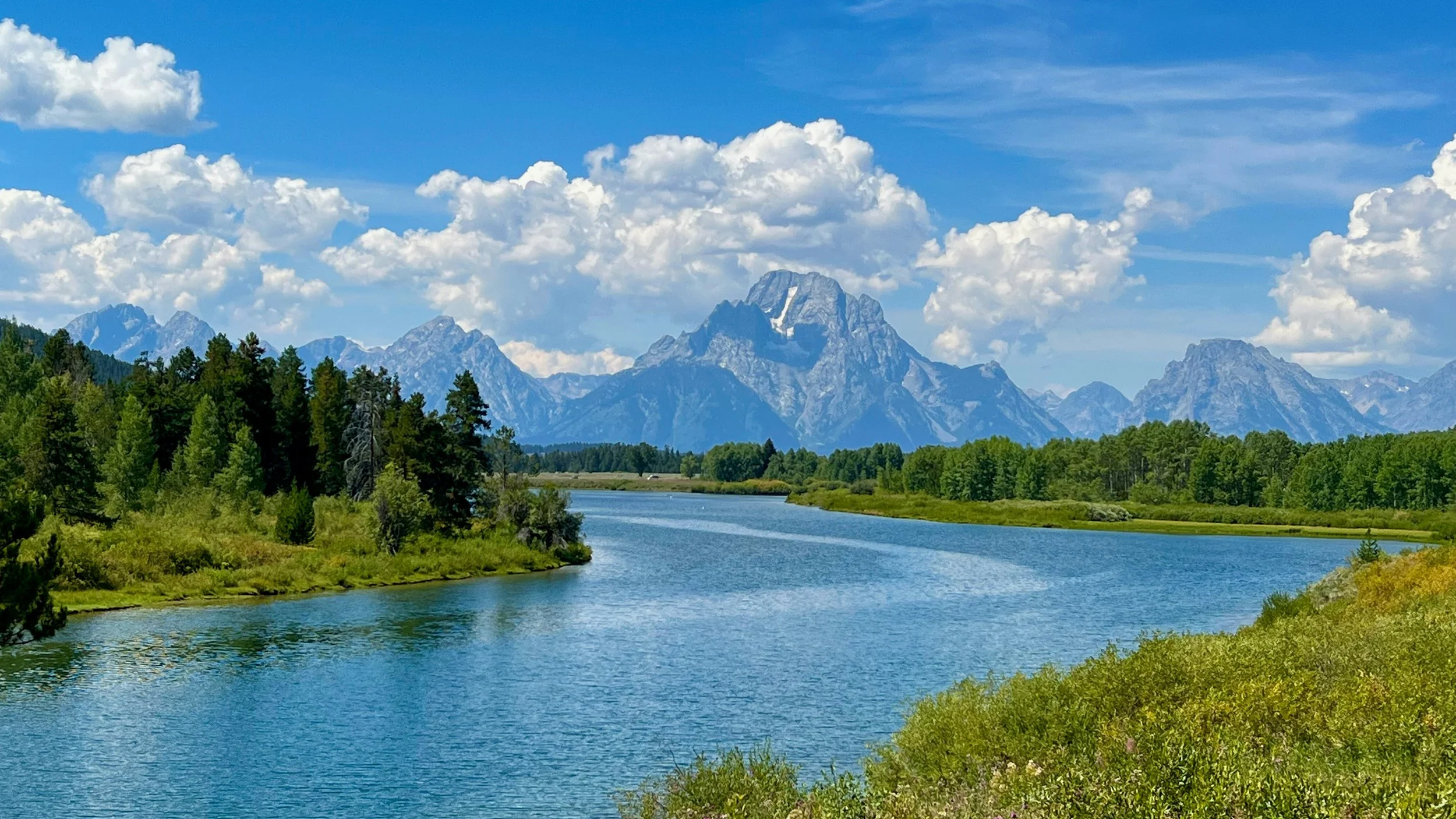 Snake River with clouds in the sky and the Grand Teton mountain range in the background representing destiny routing us on new paths