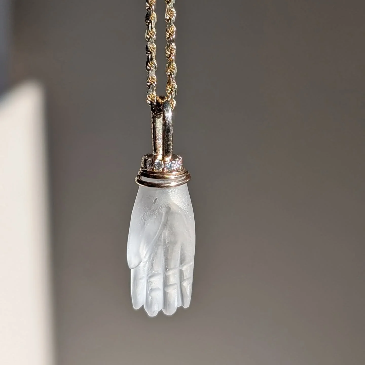 Carved quartz hand, hand fabricated 14k setting and bail, Canadian origin diamonds. One of a kind, DM to inquire. (Website listing coming soon! Like a week! For real!) 
 
"Whatever your hand finds to do, do it with all your strength, for there i