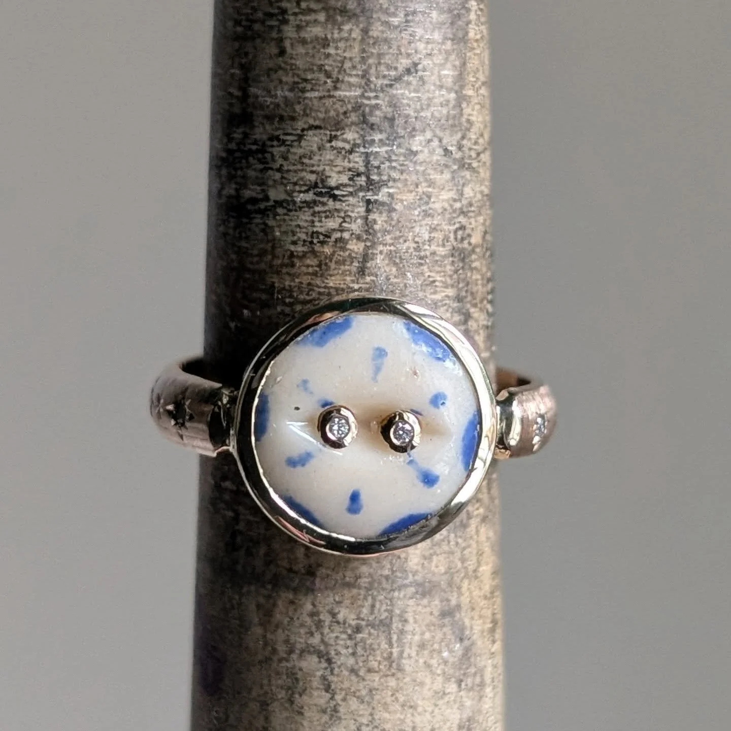 I recently finished this custom ring to celebrate a 20th wedding anniversary. China is the traditional gift for the 20th anniversary, so we decided on setting this 18th century ceramic button in gold as an ode to the tradition. Featuring rivets set w