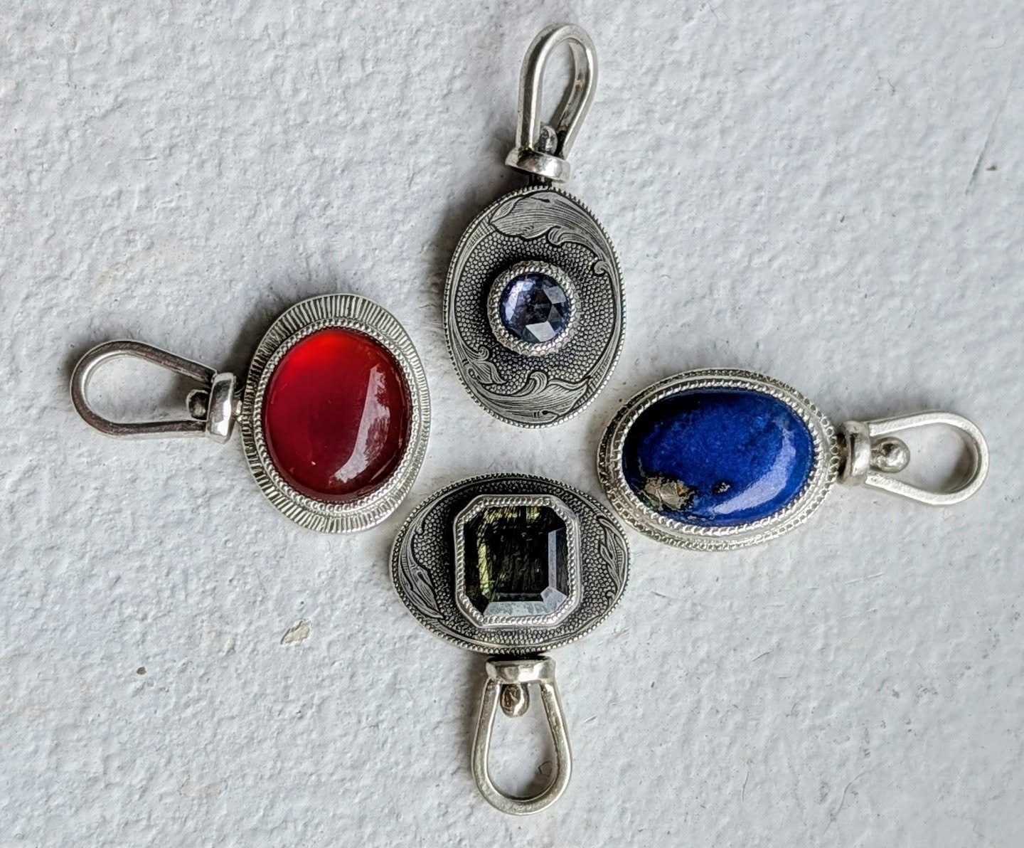 Symbol flip pendants, on a swivel. Hand engraved on 12 gauge silver, various stones. Website update in the works, DM with inquiries. 

#handmade #handengraved #jewelrygram #slowfashion #jotd