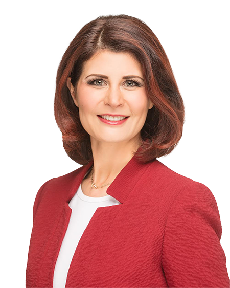 Headshot of a woman with shoulder-length reddish-brown hair, wearing a red blazer and white top, smiling.