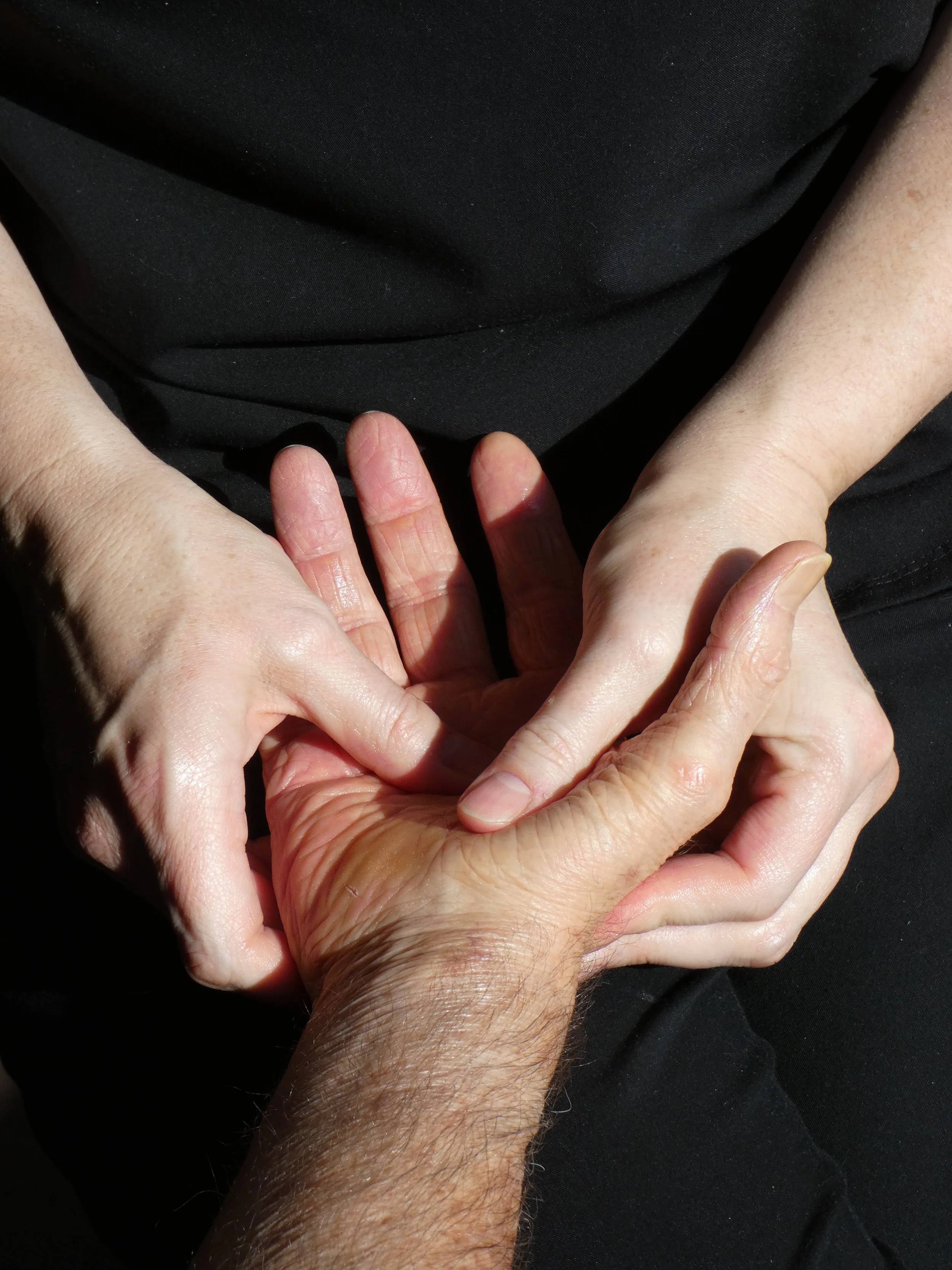 The image shows a person with a hairy arm forming a heart shape with their hands.