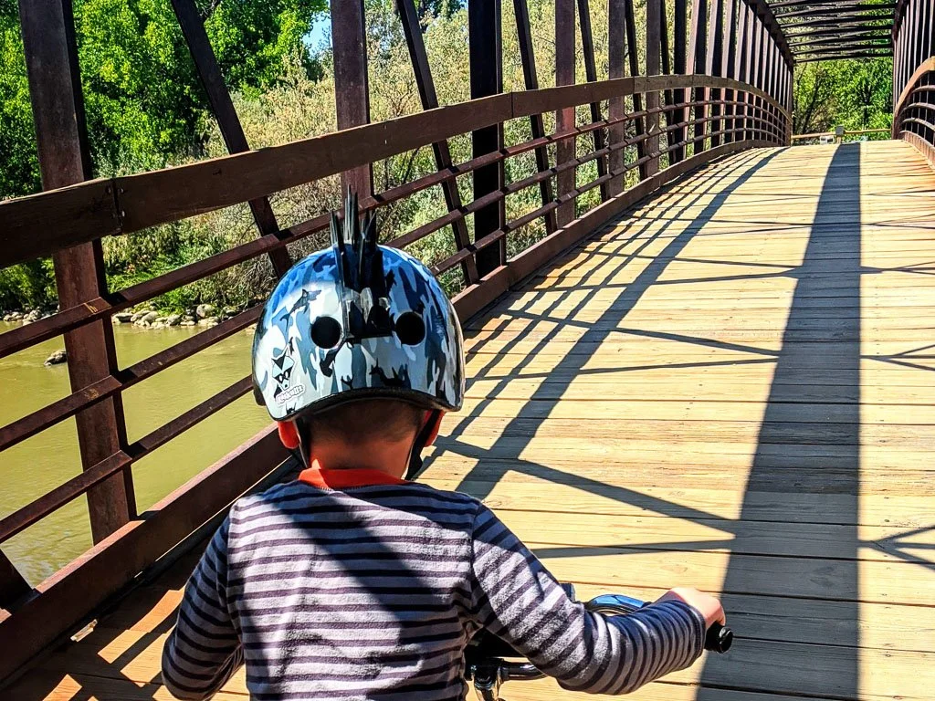 Rusted-Rose-Studios_child-biking-bridge-outdoor-adventure_01.jpg