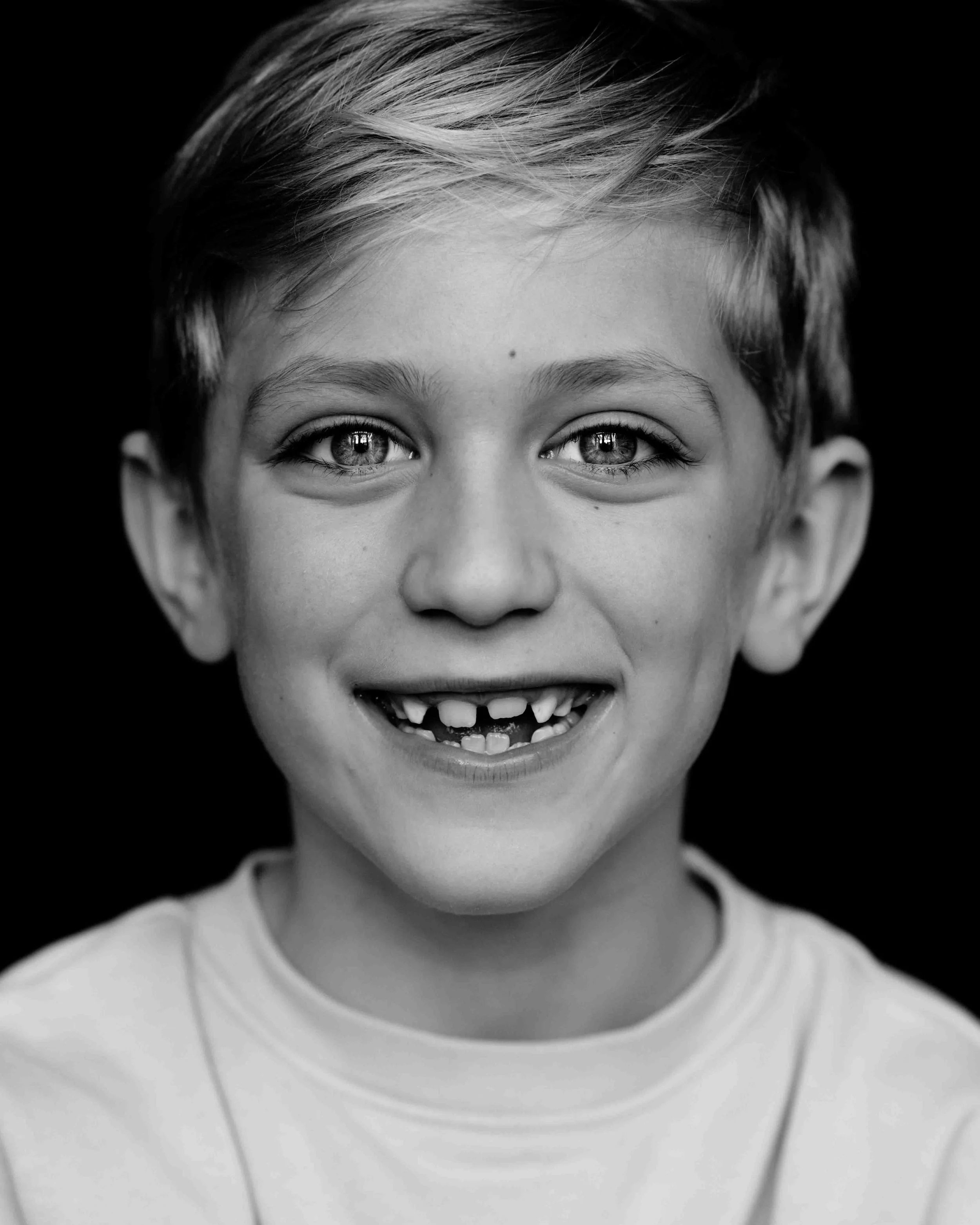 Zwart wit portretfoto van een jongen van 7 jaar. 