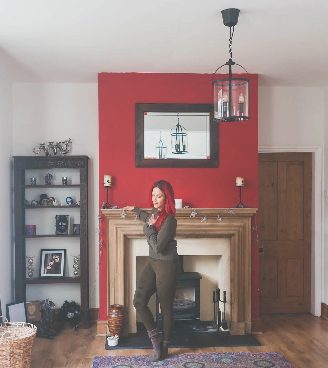 Lianna at home stood in front of a fire place