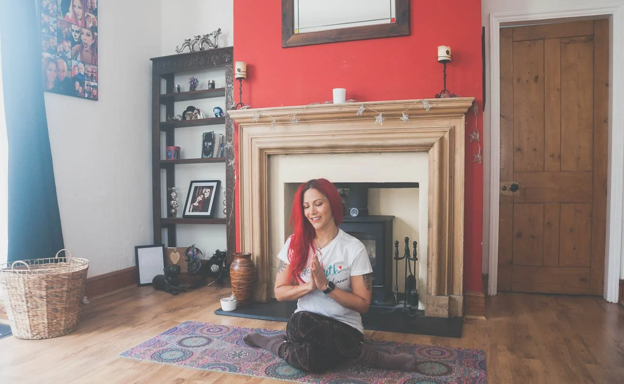 Lianna sat on a yoga mat in Lotus Pose