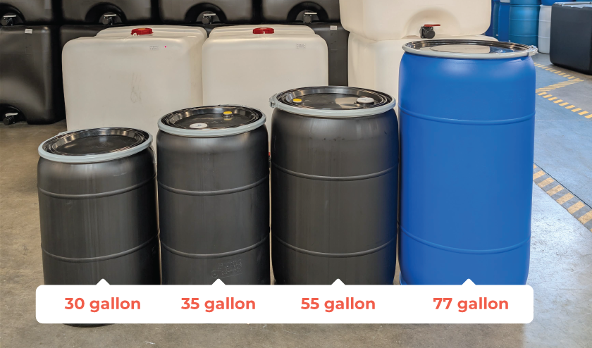 Four large water storage barrels in a row, labeled with different capacities: 30 gallon, 35 gallon, 55 gallon, and 77 gallon, in front of a display of two white and two black containers.