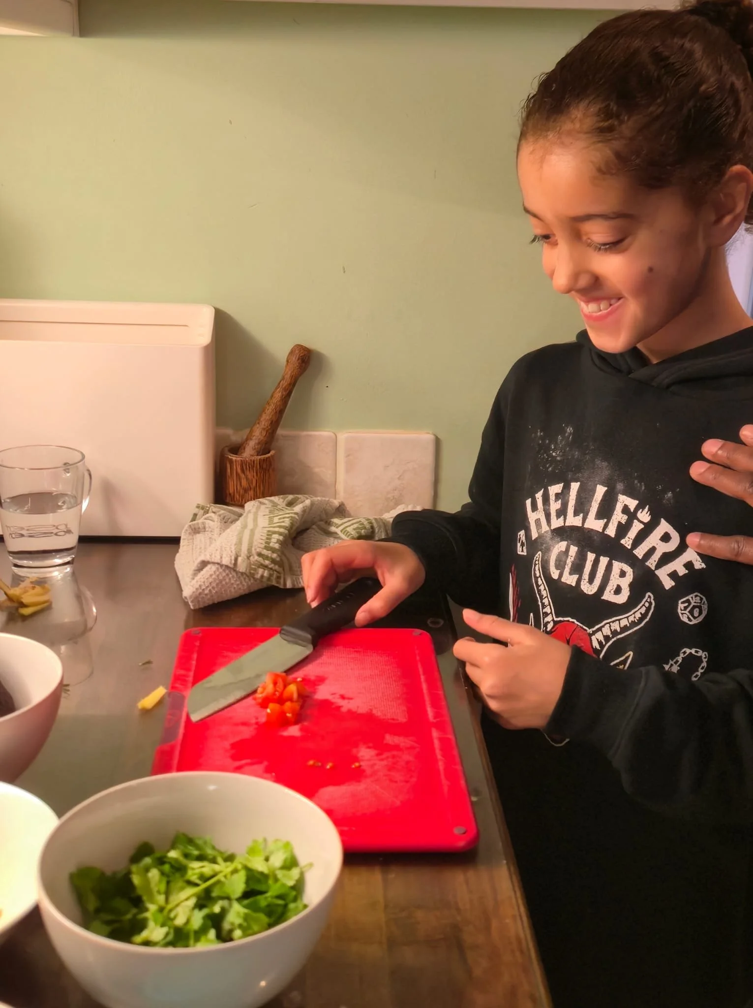 Home ed cooking class - Maddie chopping tomatoes to make Mango salsa