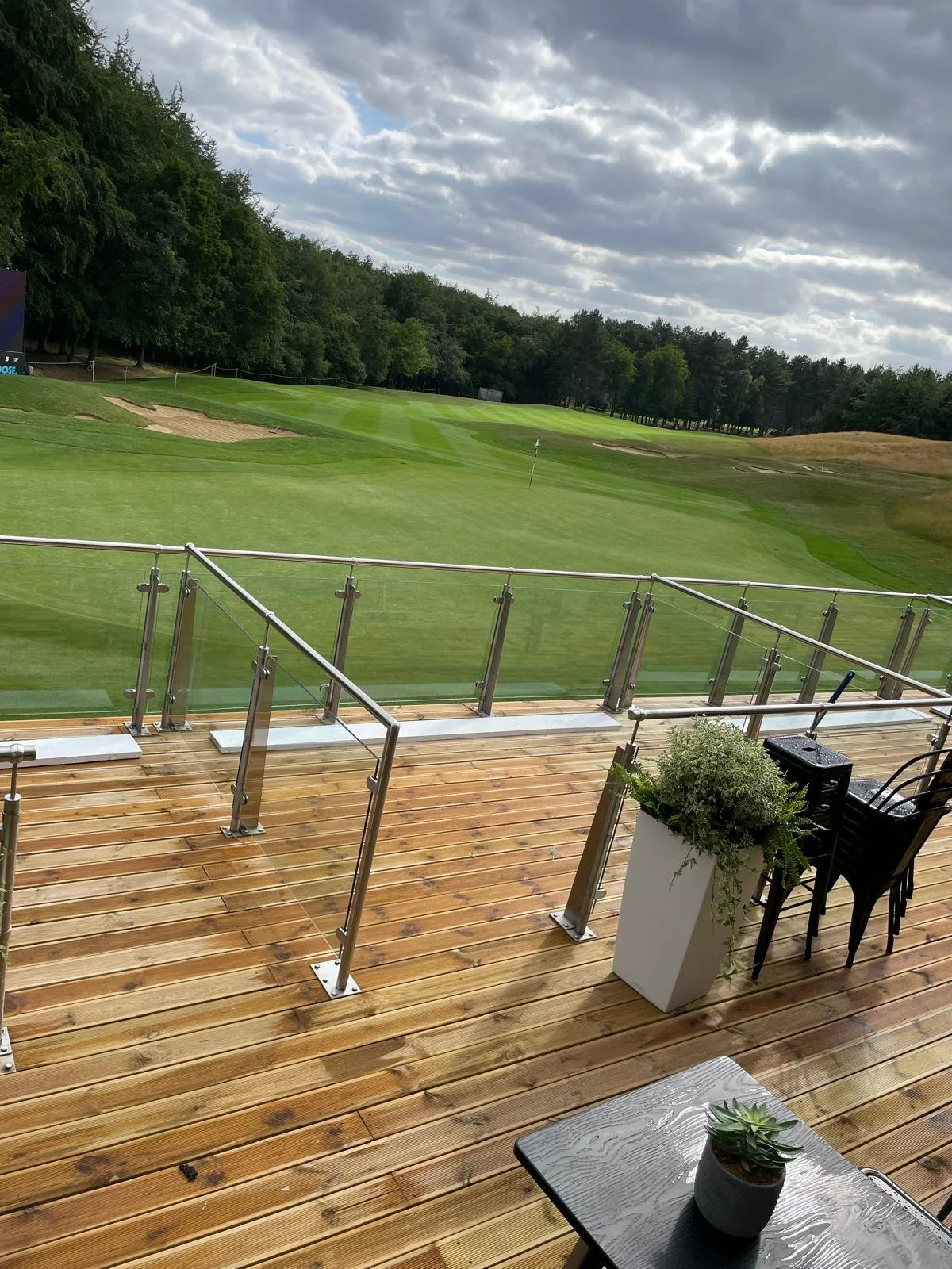 Professional glass balustrade cleaning at a golf course, leaving the glass spotless and clear