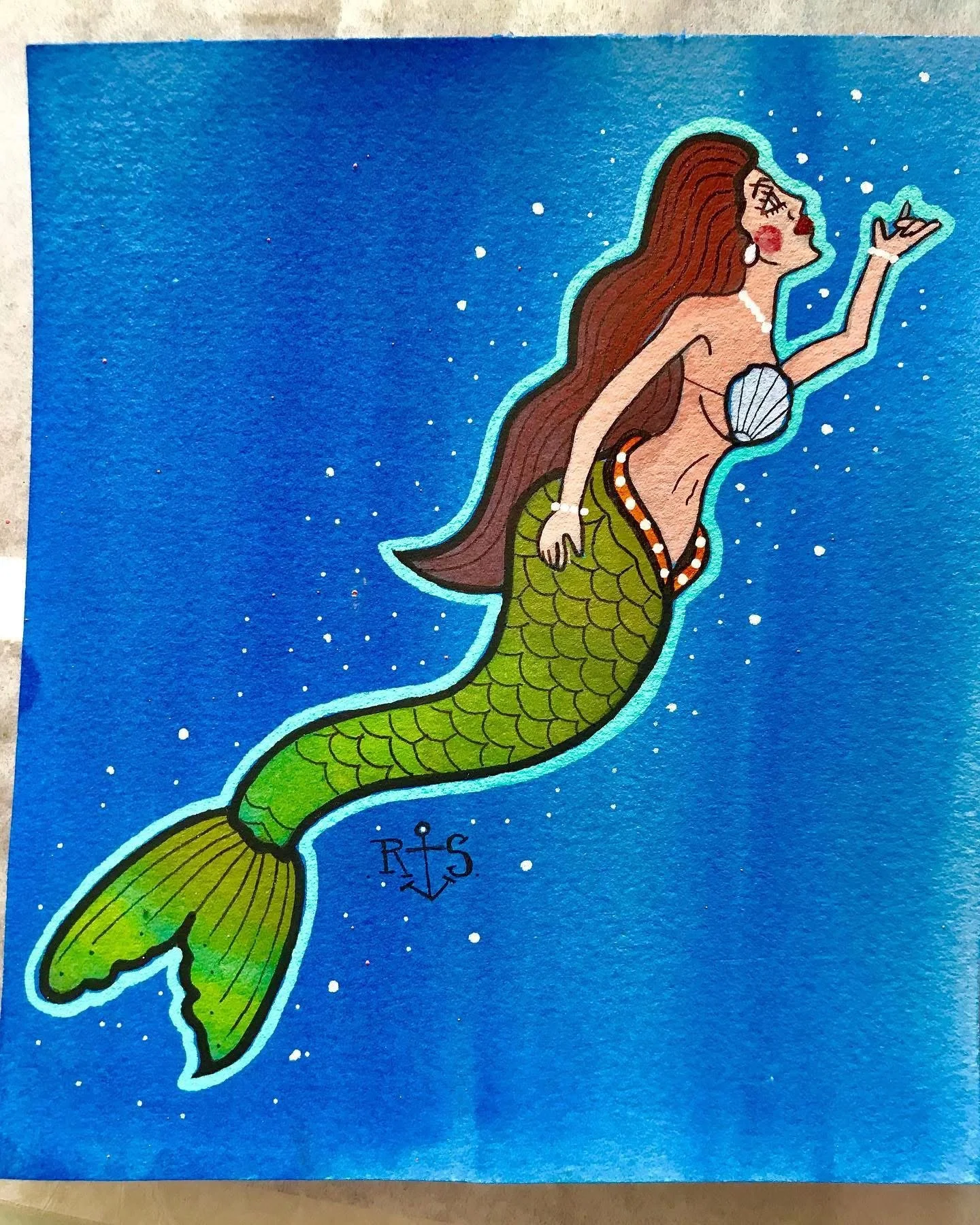Illustration of a mermaid with long brown hair, wearing a shell top and green fish tail, holding a shell and blowing a kiss, set against a blue starry background.