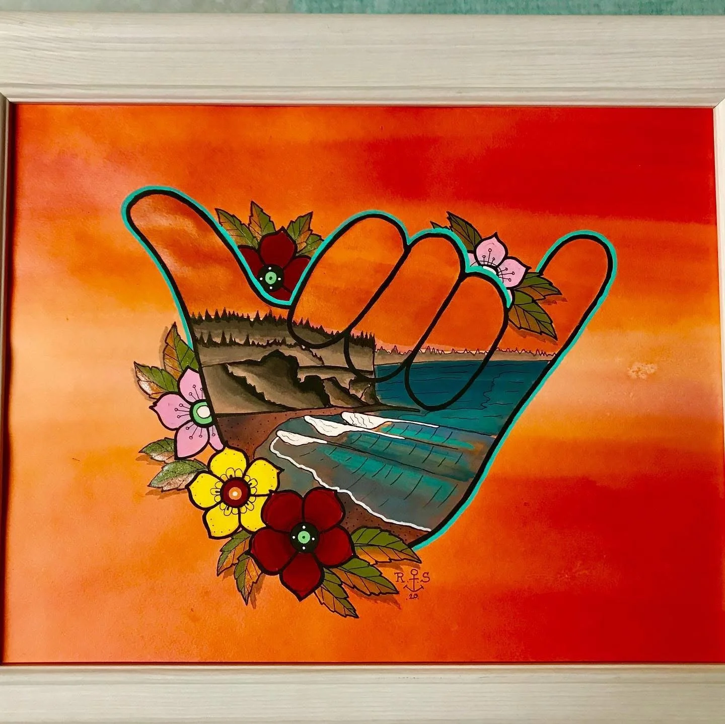 A colorful painting of a hand making a shaka sign with a tropical landscape inside the hand, flowers around the wrist, and a sunset background.