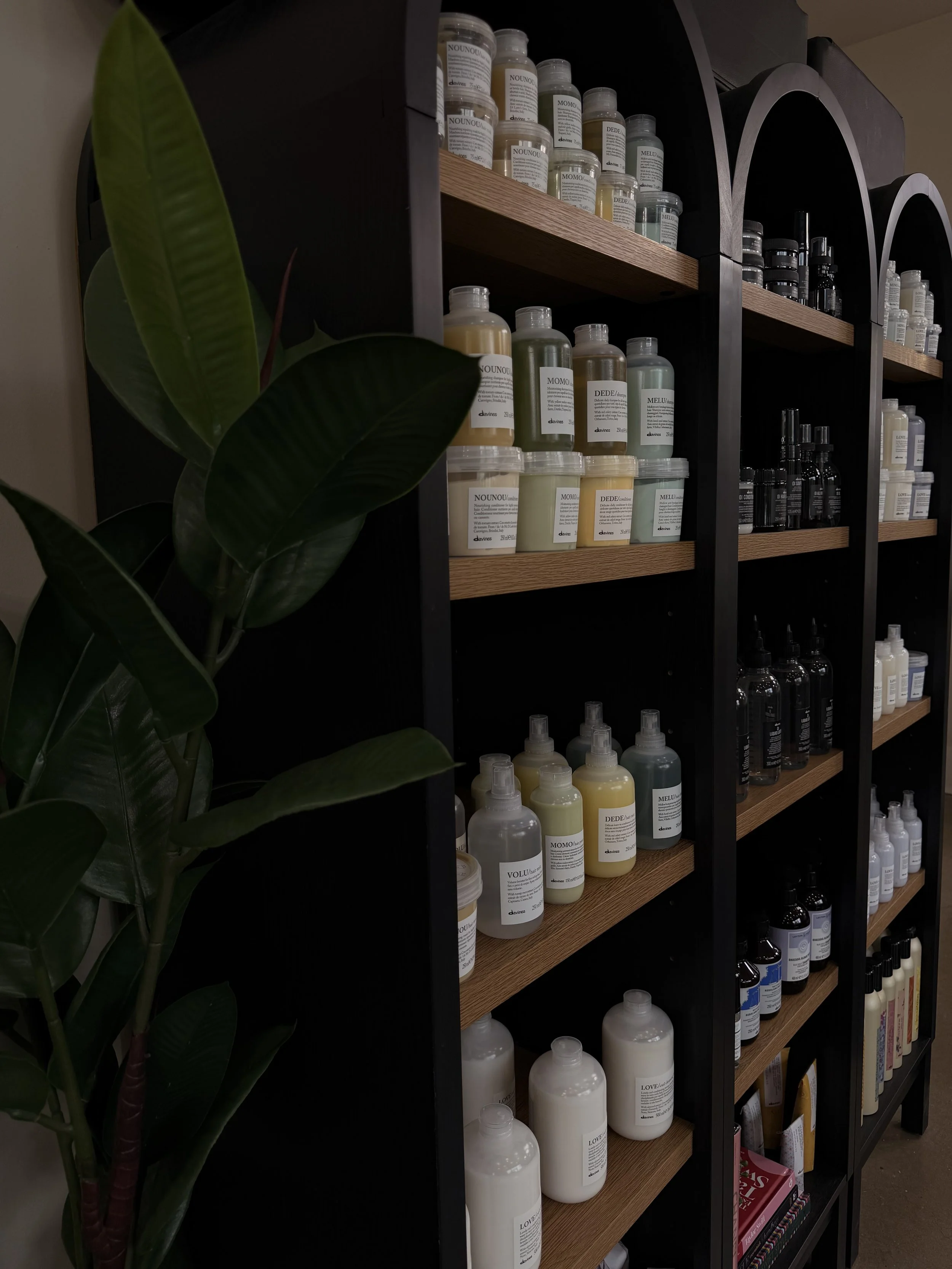 Shelves filled with various bottles of skincare products in a salon or spa setting.