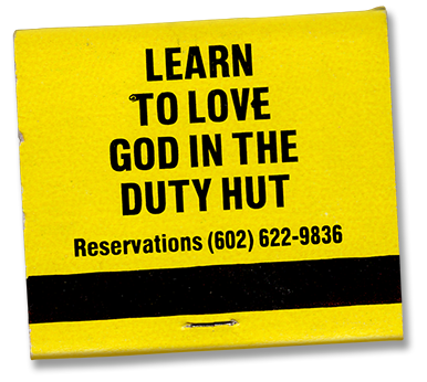 Yellow matchbook with black text that reads "Learn to Love God in the Duty Hut" and provides a reservation phone number.