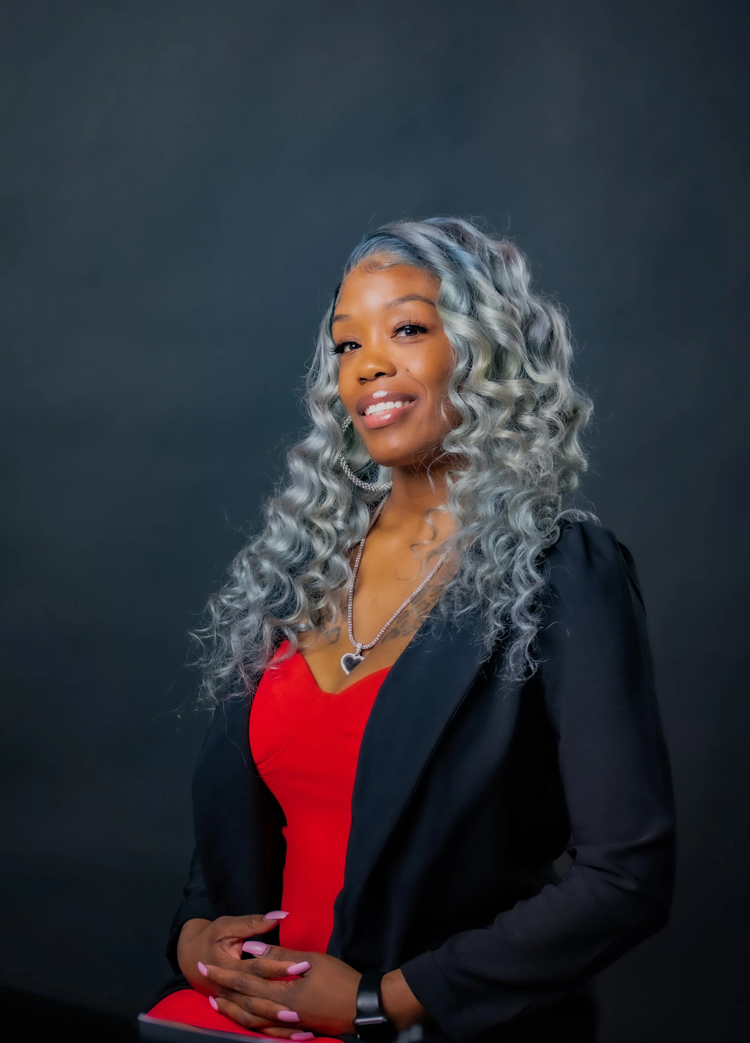 Smiling woman in a black blazer posing for a corporate headshot with T3 Mobile Studio.