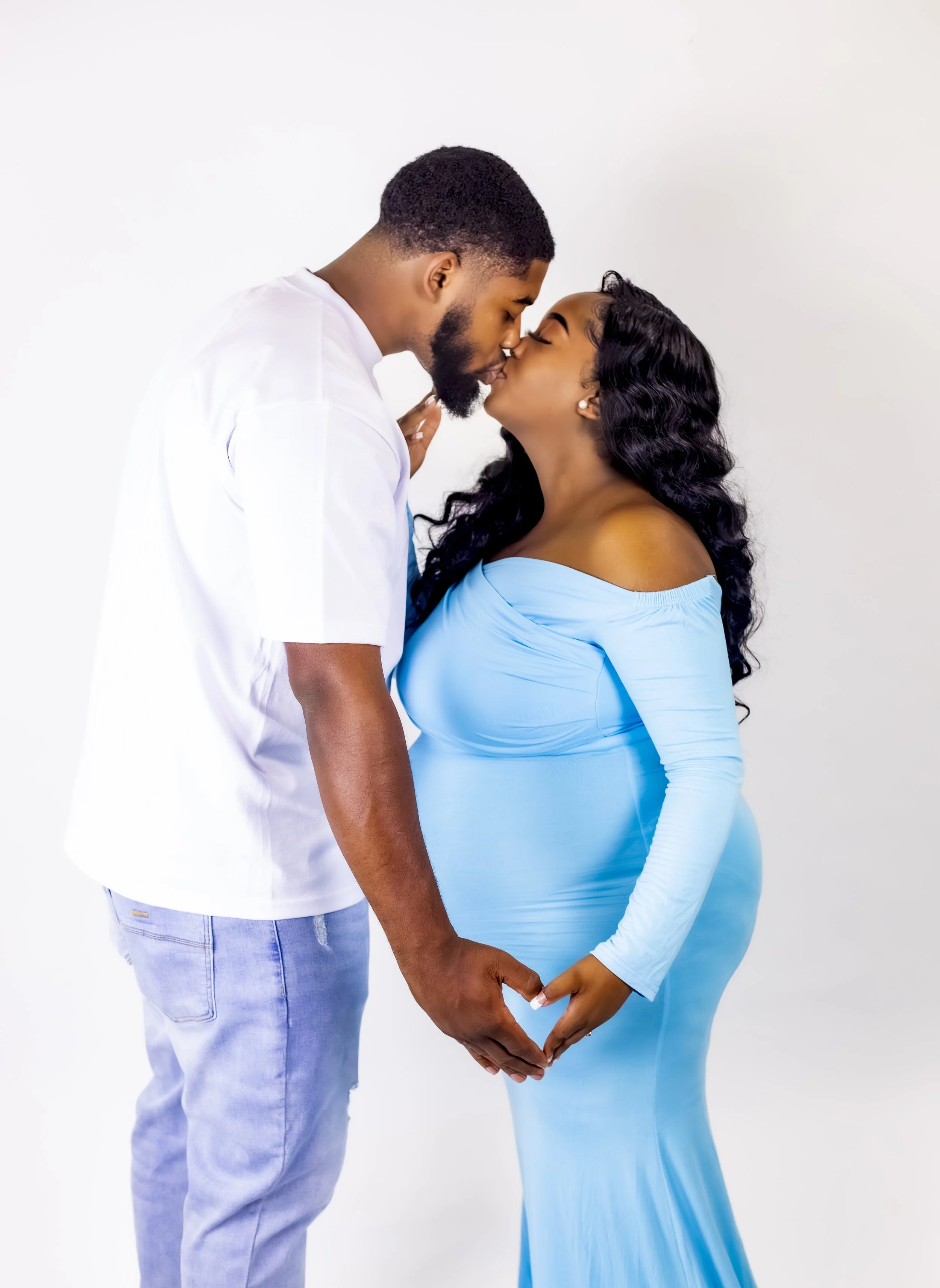 Couple sharing a sweet maternity moment during a private portrait session with T3 Mobile Studio.