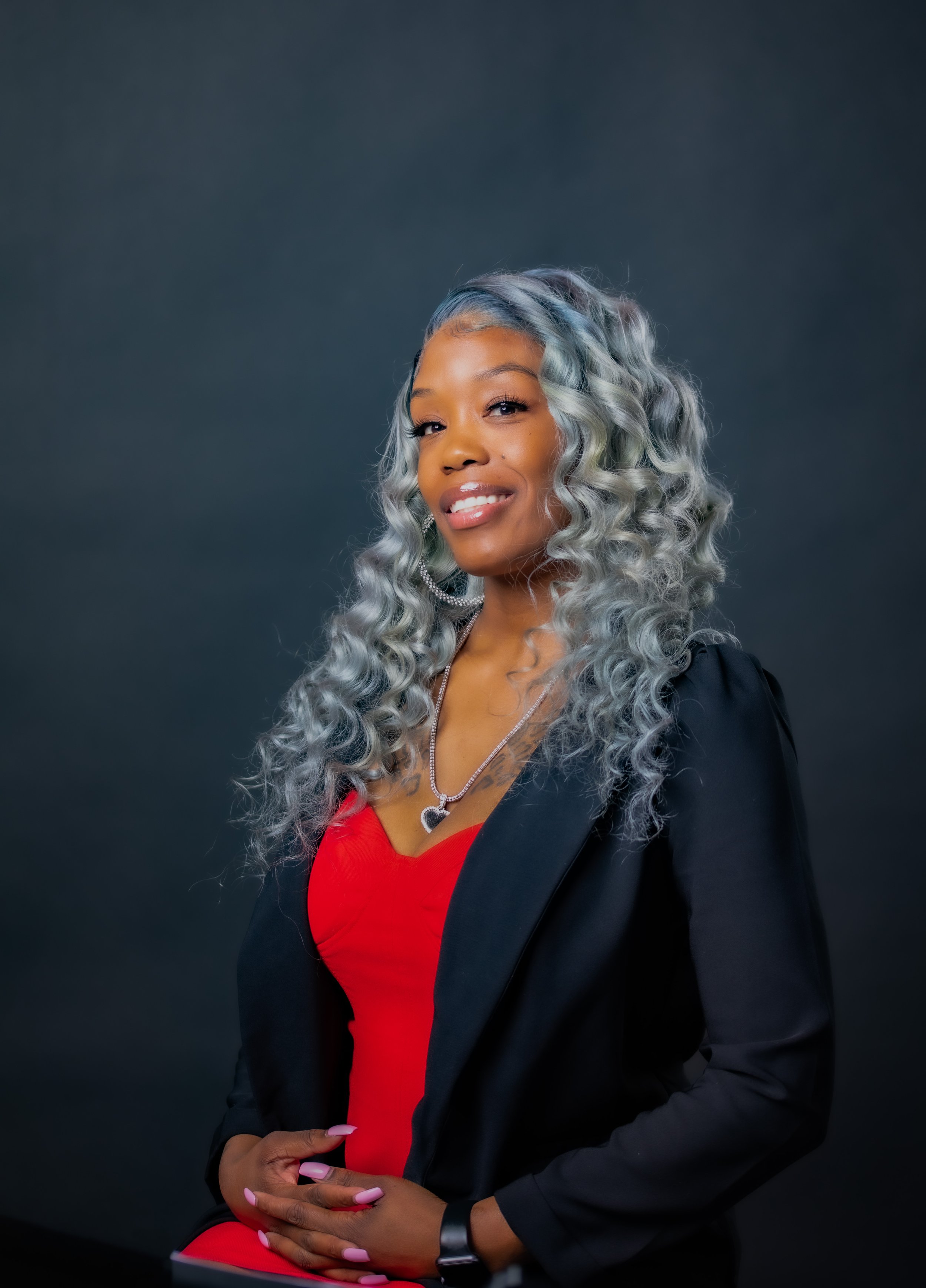 Smiling woman in a black blazer posing for a corporate headshot with T3 Mobile Studio.