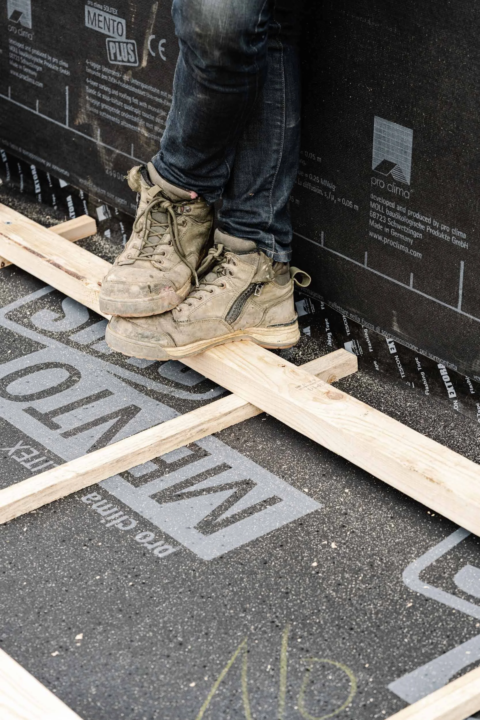 construction boots on a building membrane tilt-scroll