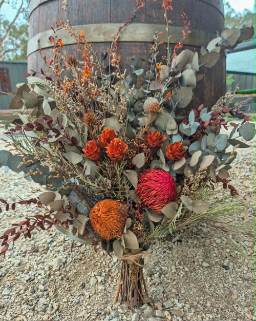Deep pink dried arrangement in a black fluted vase