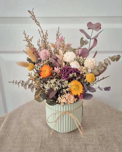 Orange banksia and mauve hydrangea styled on a table