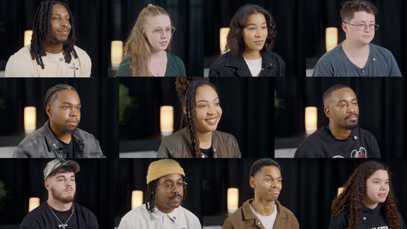 Nine diverse individuals sitting in a studio with black curtains and warm lighting, participating in a discussion or interview.
