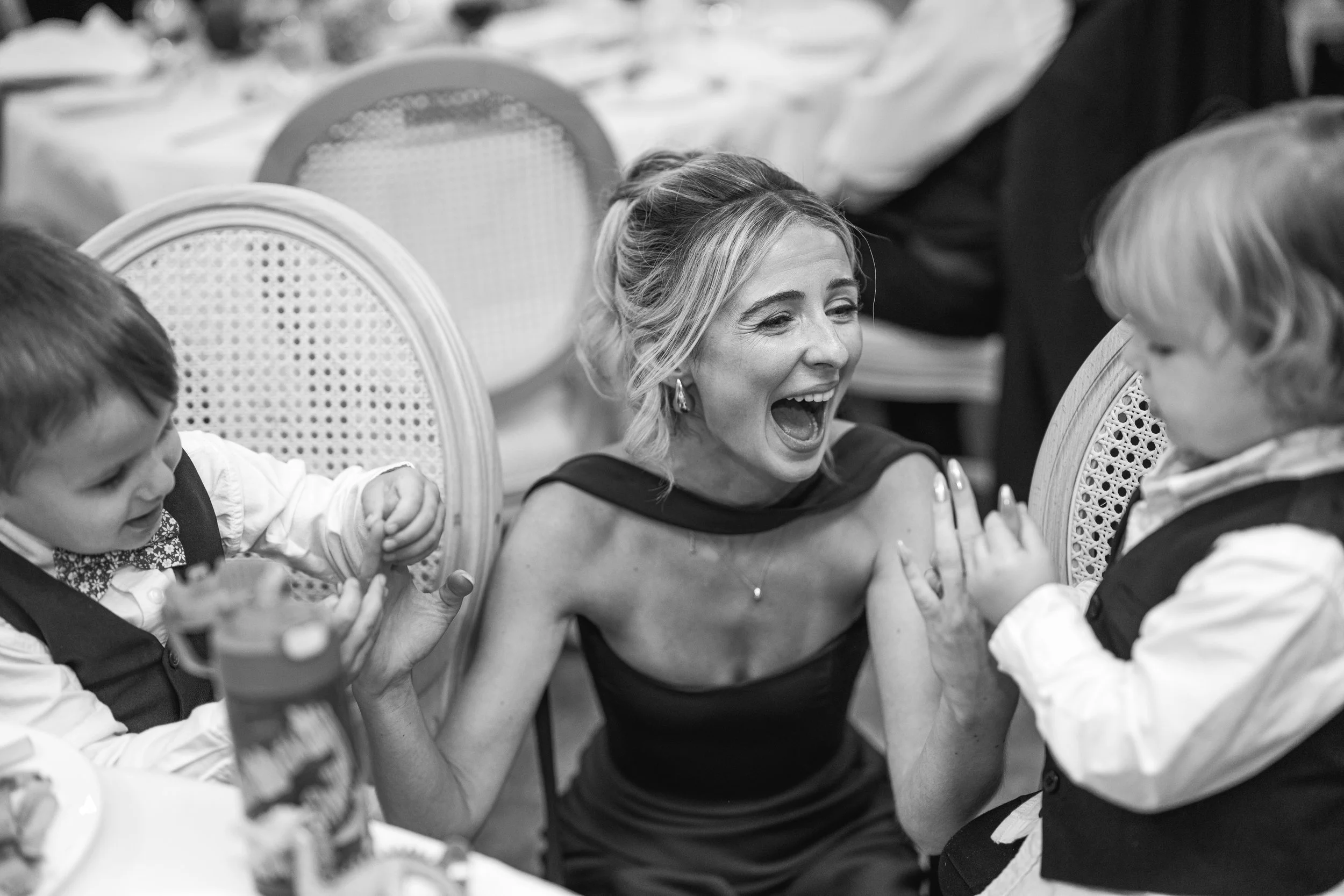 bridesmaid laughing and playing with kids