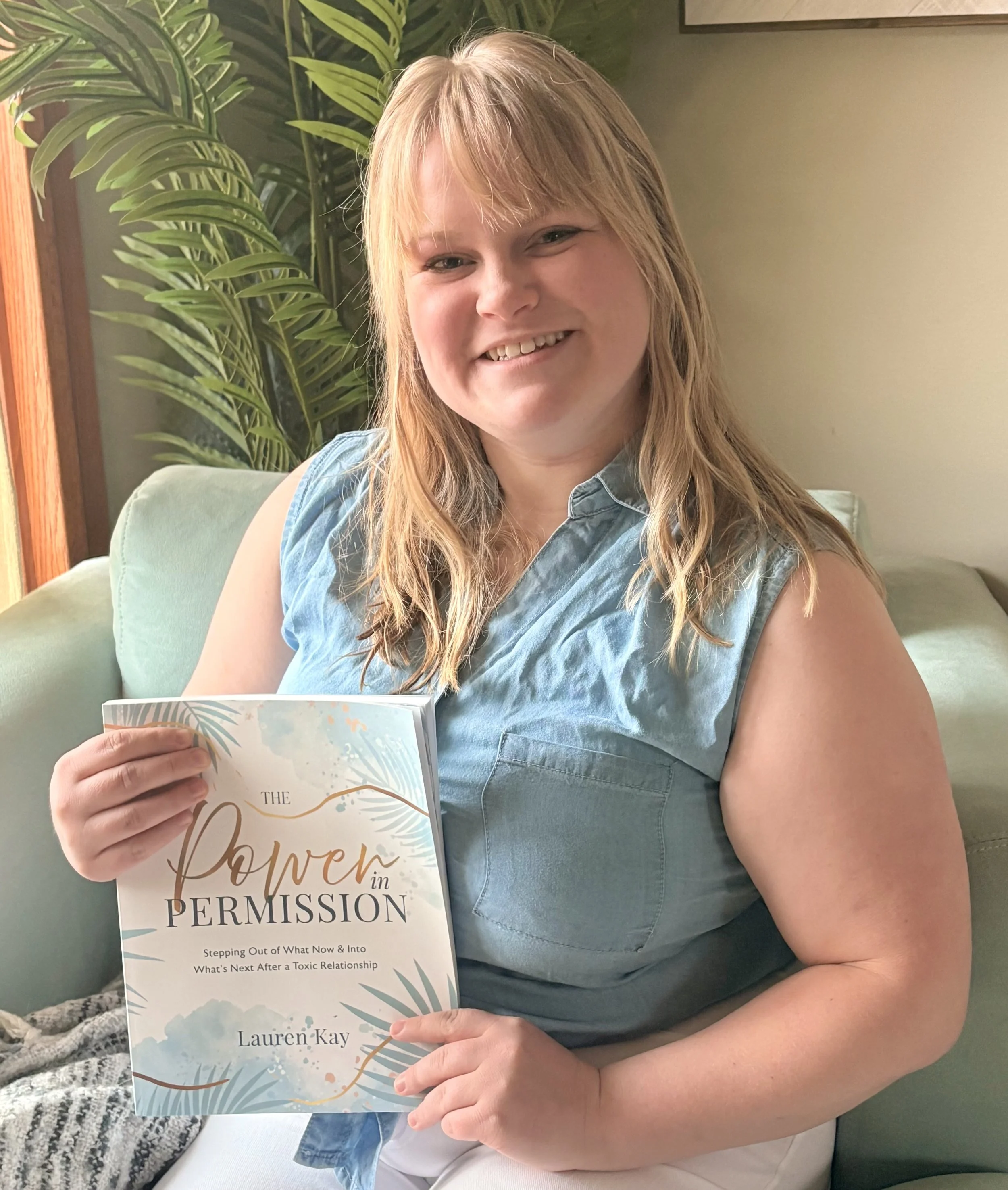 Lauren holding her newest book release 'The Power in Permission' workbook, available now
