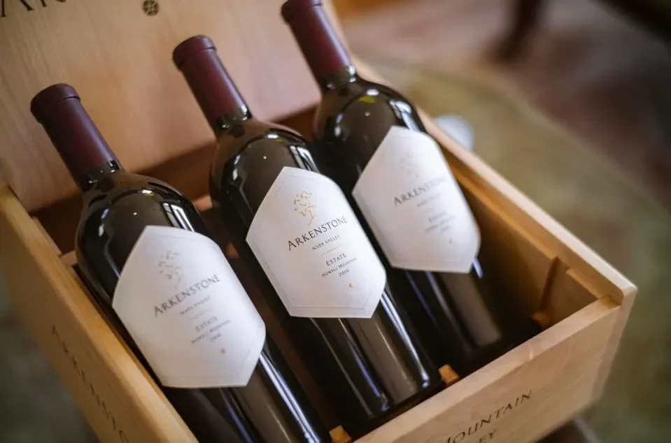 Three bottles of Arkenstone wine in a wooden box.