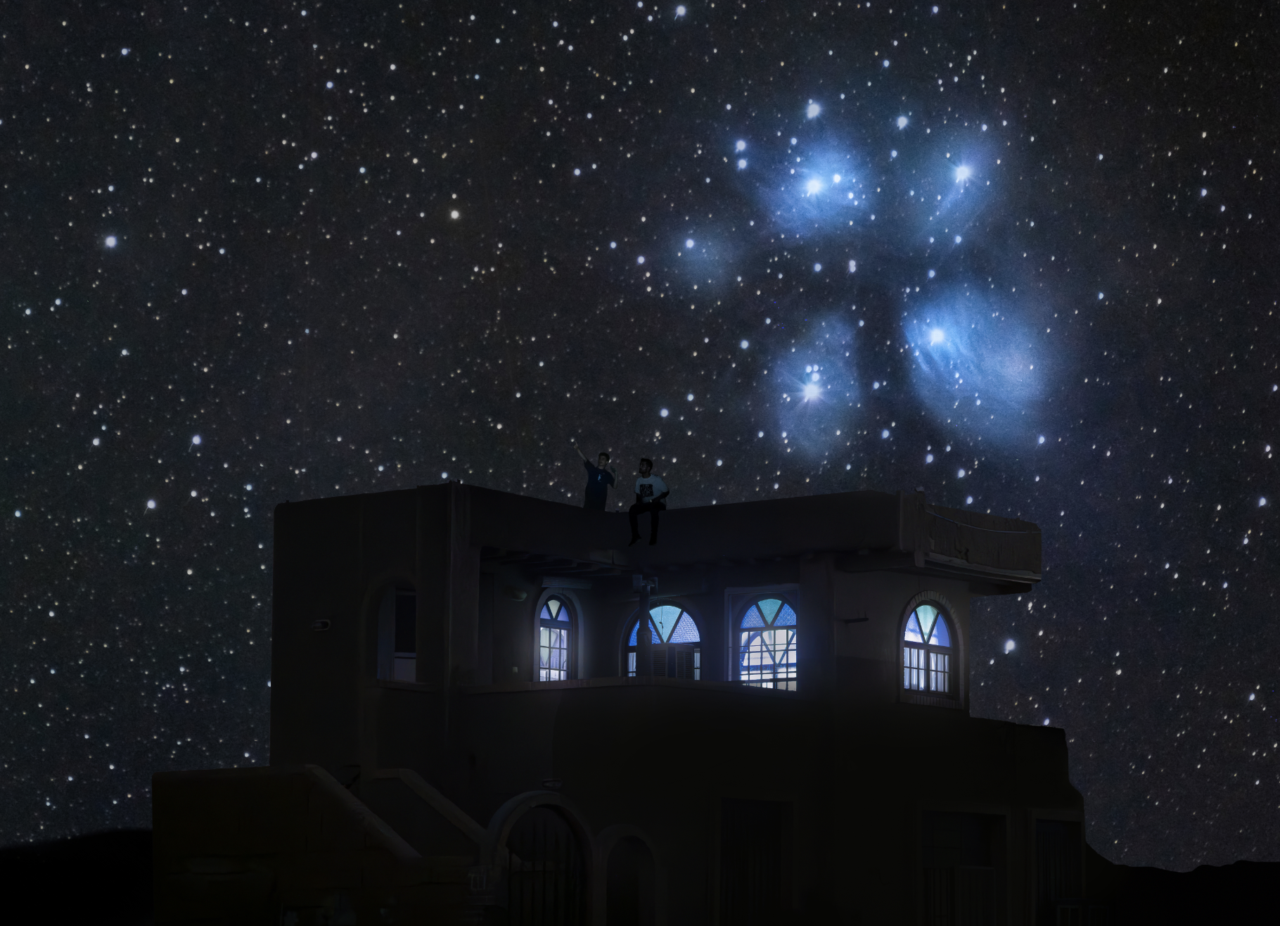 Night sky filled with stars and the Pleiades star cluster over a house with illuminated windows, with two children sitting on the roof looking at the sky.
