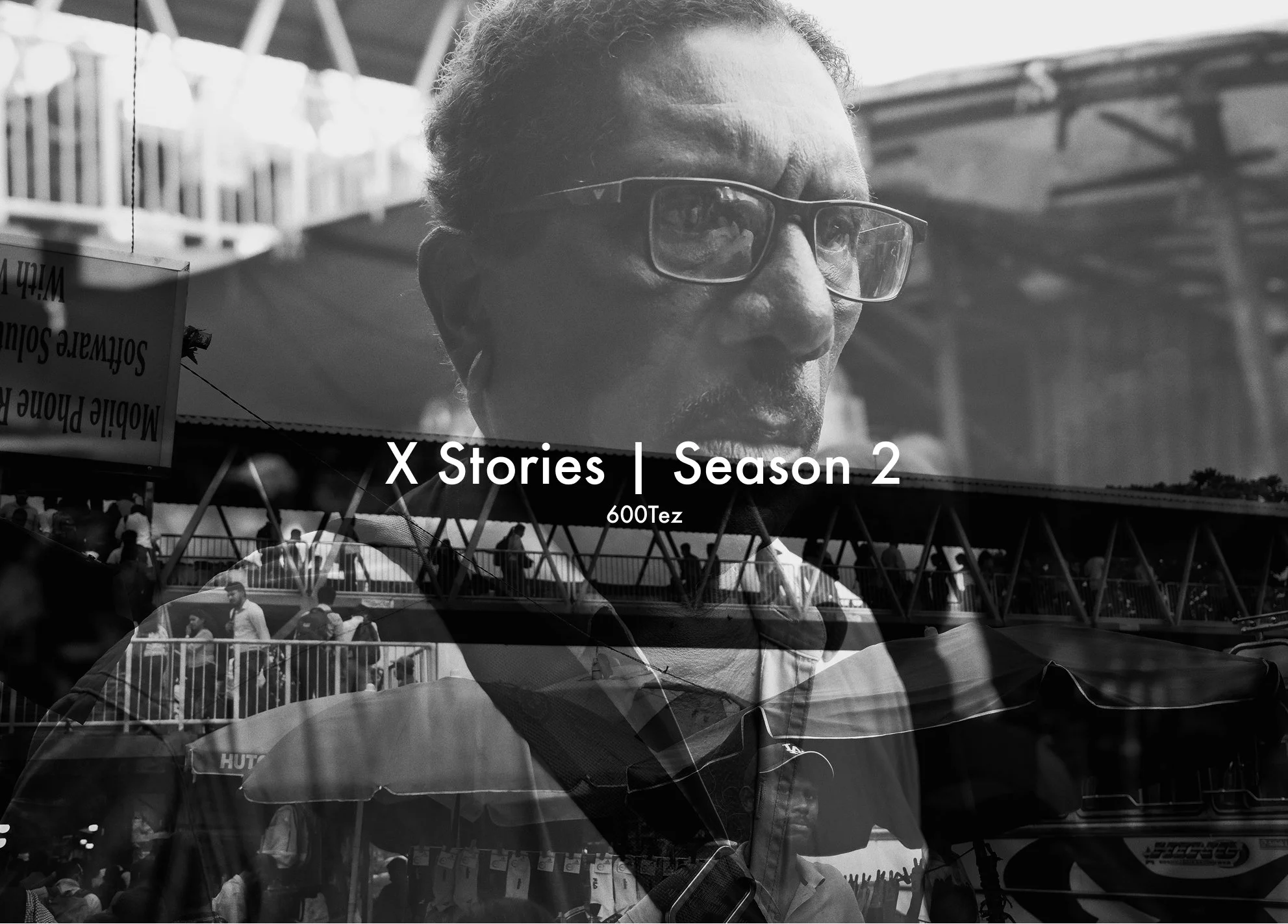 A man wearing glasses at an outdoor event with a crowd and structures in the background, overlaid with the text "X Stories | Season 2" and "600Tez".